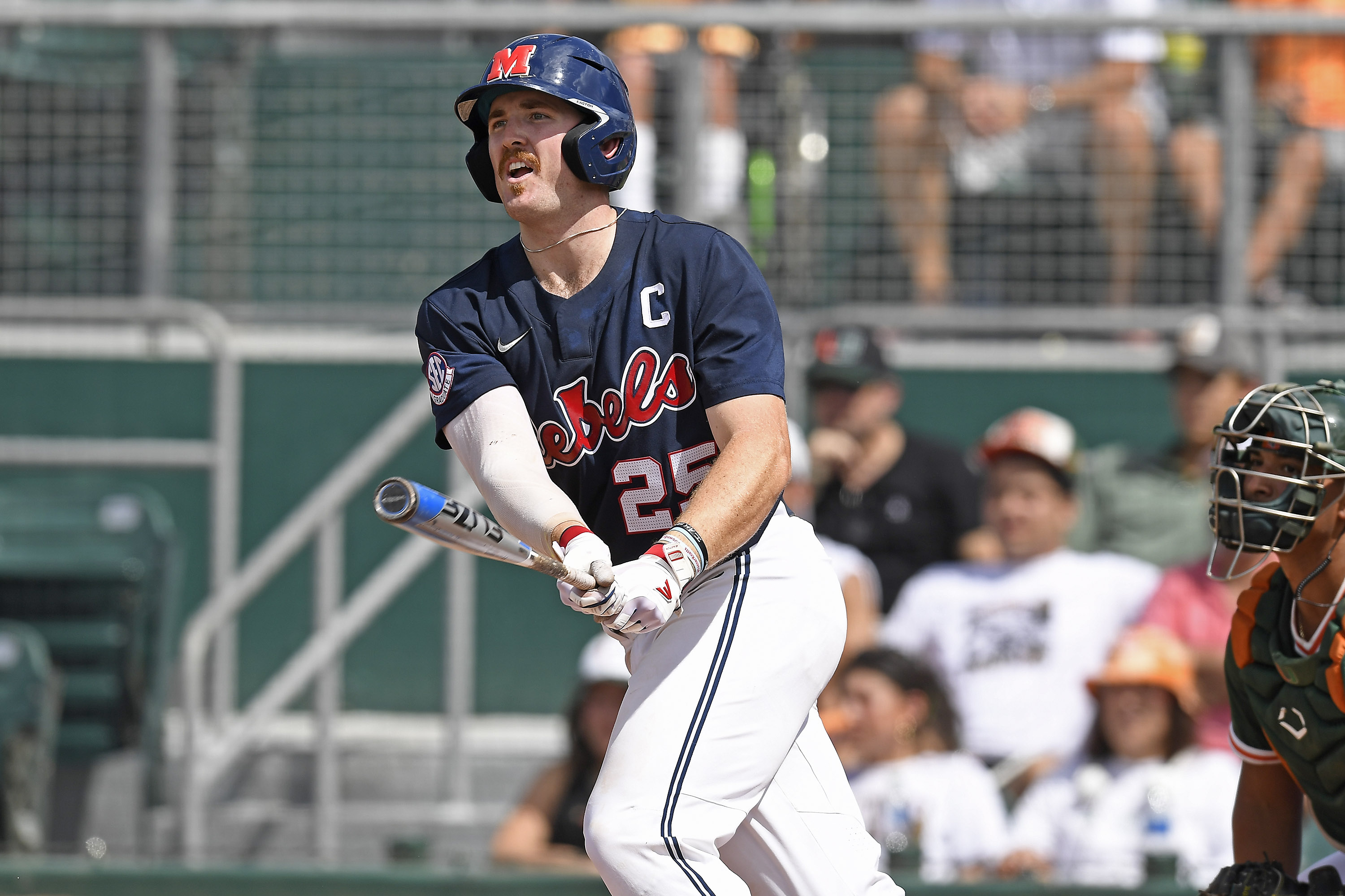CORAL GABLES, FL - JUNE 05: Ole Miss infielder/outfielder Tim Elko (25) hits a double in the first inning as the University of Miami Hurricanes faced the University of Mississippi Ole Miss Rebels in the Coral Gables Regional on June 5, 2022, at Mark Light Field at Alex Rodriguez Park in Coral Gables, Florida. (Photo by Samuel Lewis/Icon Sportswire via Getty Images)