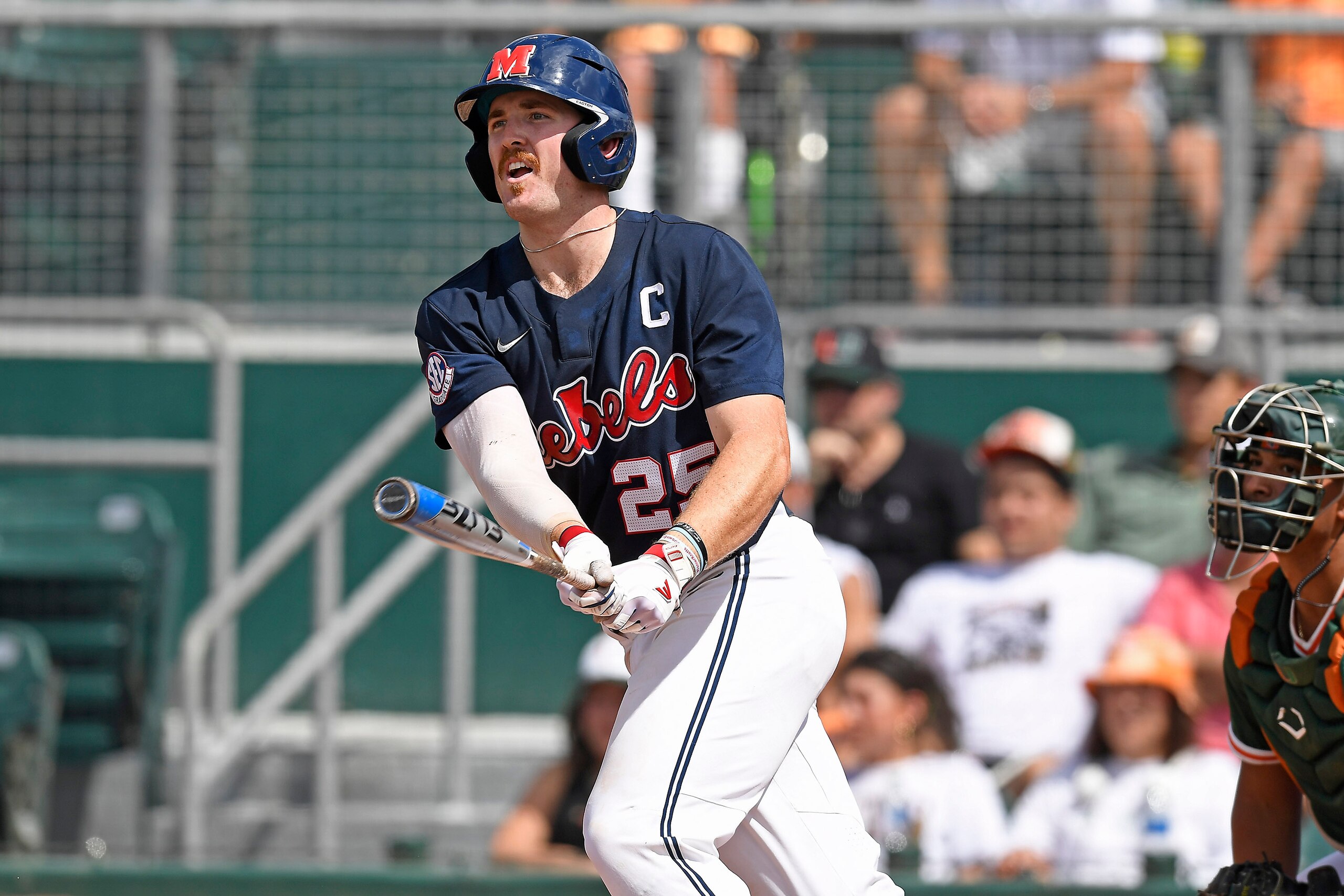 CORAL GABLES, FL - JUNE 05: Ole Miss infielder/outfielder Tim Elko (25) hits a double in the first inning as the University of Miami Hurricanes faced the University of Mississippi Ole Miss Rebels in the Coral Gables Regional on June 5, 2022, at Mark Light Field at Alex Rodriguez Park in Coral Gables, Florida. (Photo by Samuel Lewis/Icon Sportswire via Getty Images)