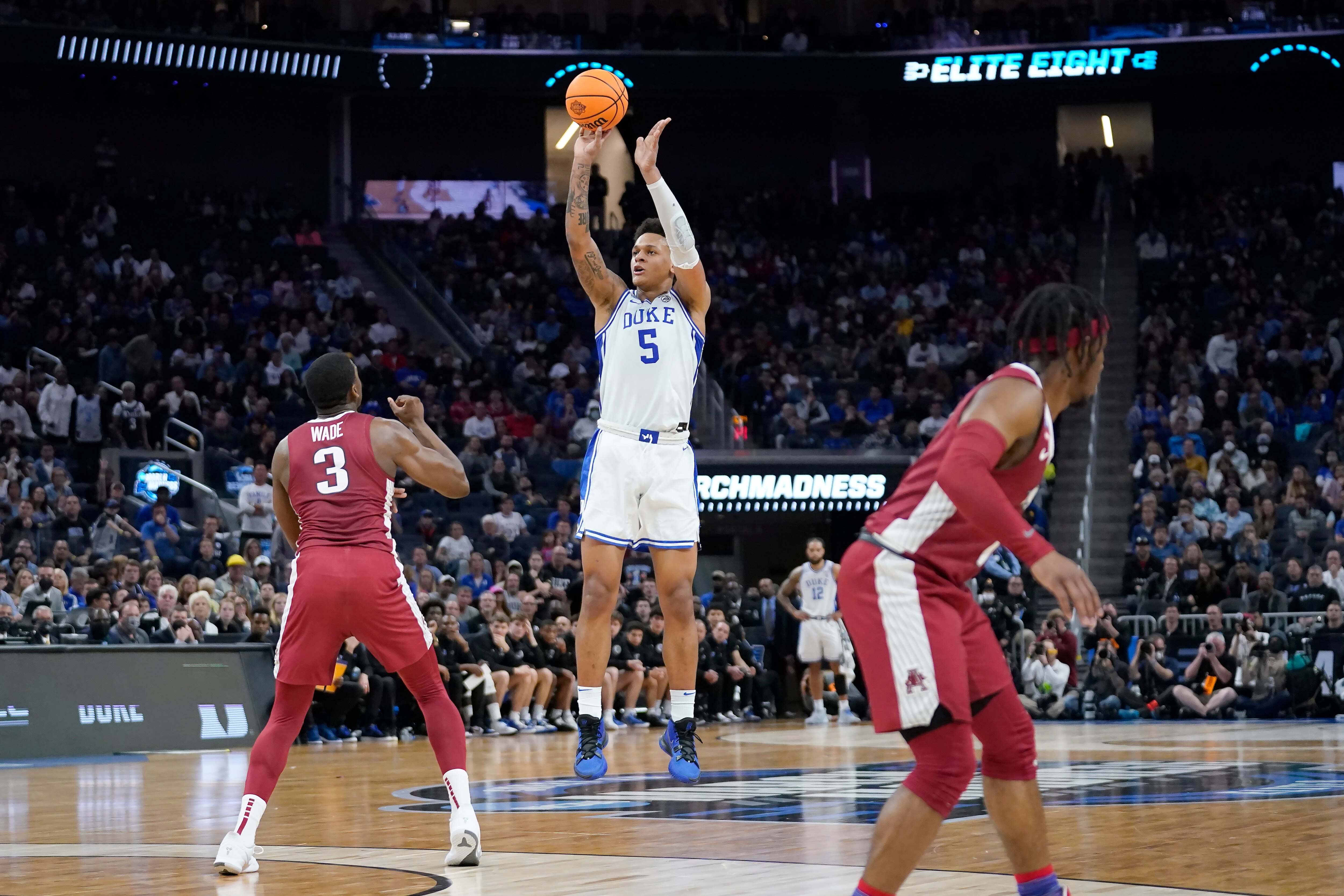 Duke forward Paolo Banchero (5) shoots a three point basket against Arkansas forward Trey Wade (3) during the first half of a college basketball game in the Elite 8 round of the NCAA men's tournament in San Francisco, Saturday, March 26, 2022. (AP Photo/Marcio Jose Sanchez)