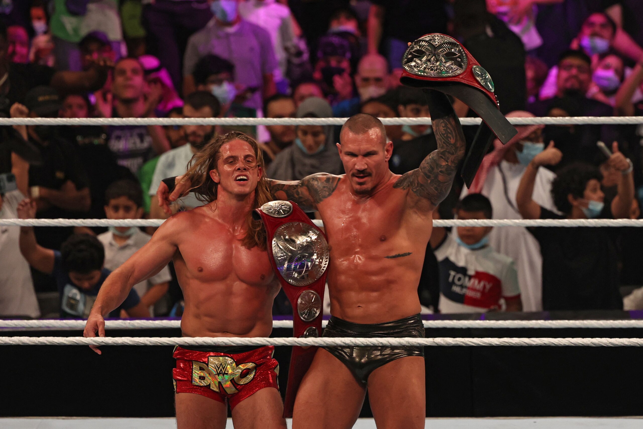 Randy Orton (R) and Riddle celebrate their win in the World Wrestling Entertainment (WWE) Crown Jewel pay-per-view in the Saudi capital Riyadh on October 21, 2021. (Photo by Fayez Nureldine / AFP) (Photo by FAYEZ NURELDINE/AFP via Getty Images)