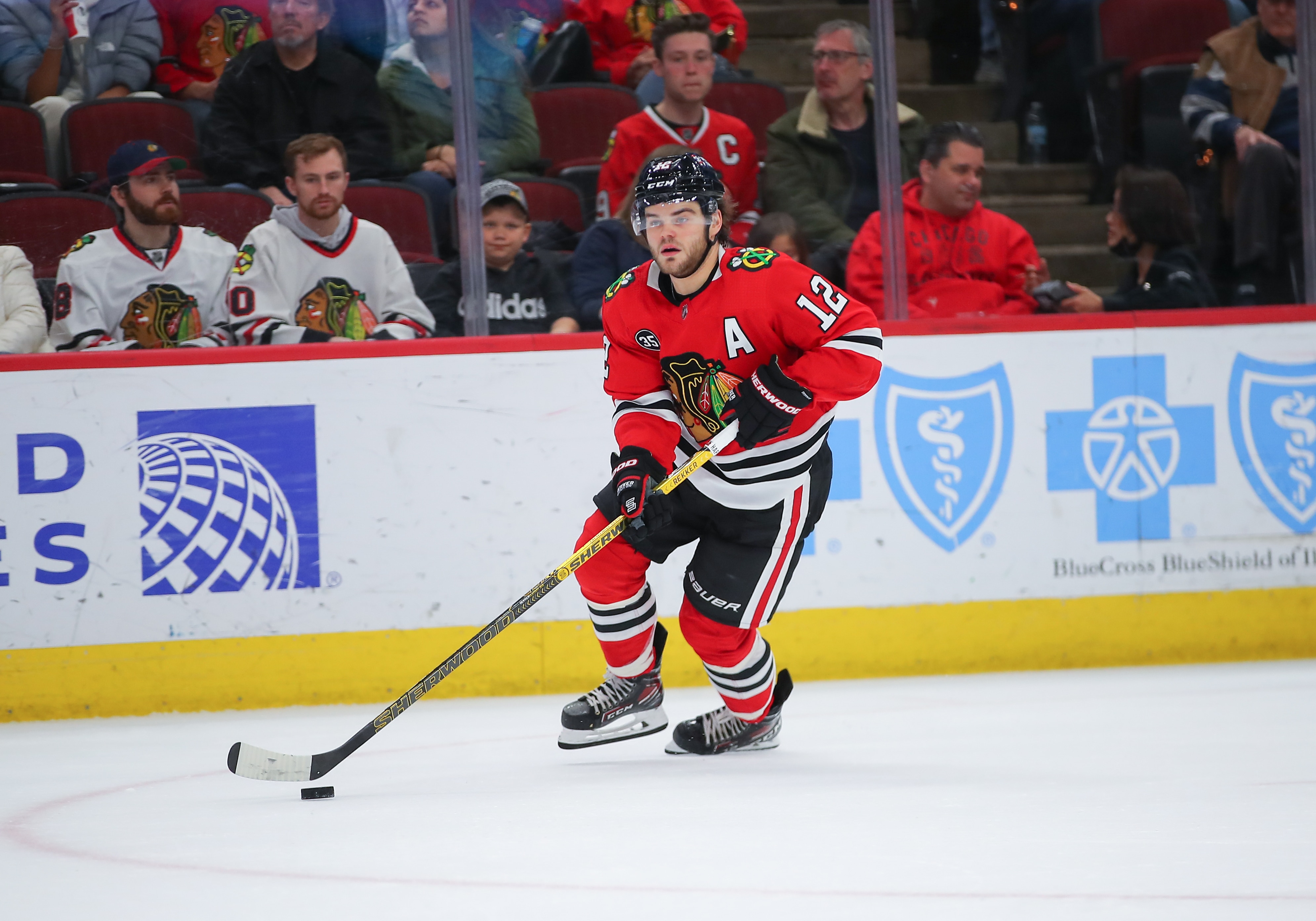 CHICAGO, IL - APRIL 12: Chicago Blackhawks left wing Alex DeBrincat (12) skates with the puck in action during a game between the Los Angeles Kings and the Chicago Blackhawks on April 12, 2022 at the United Center in Chicago, IL. (Photo by Melissa Tamez/Icon Sportswire via Getty Images)