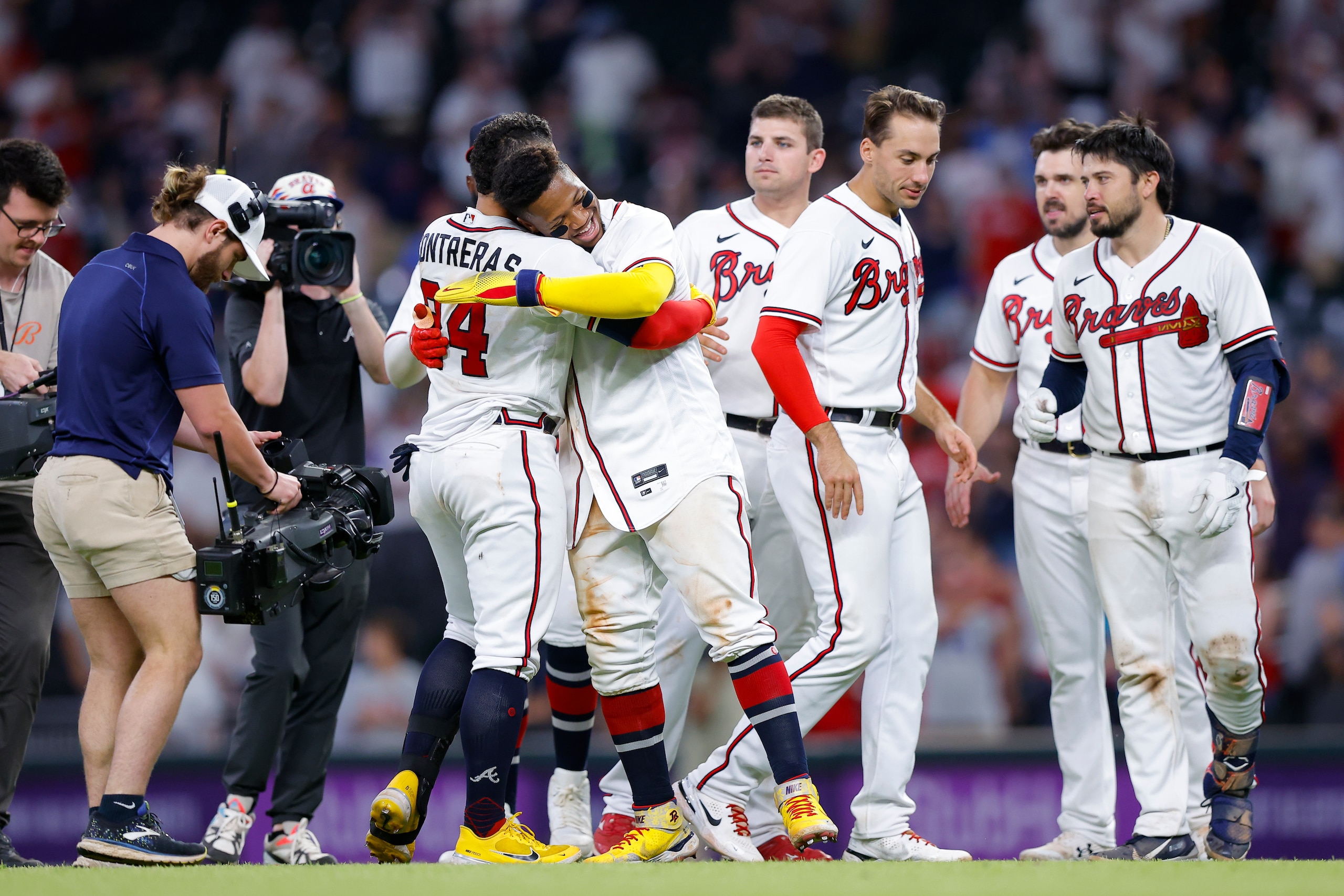 Atlanta Braves William Contreras (24) reacts with Ronald Acuna Jr. after his game winning single in the ninth inning of a baseball game against the Philadelphia Phillies, Tuesday, May 24, 2022, in Atlanta. (AP Photo/Todd Kirkland)