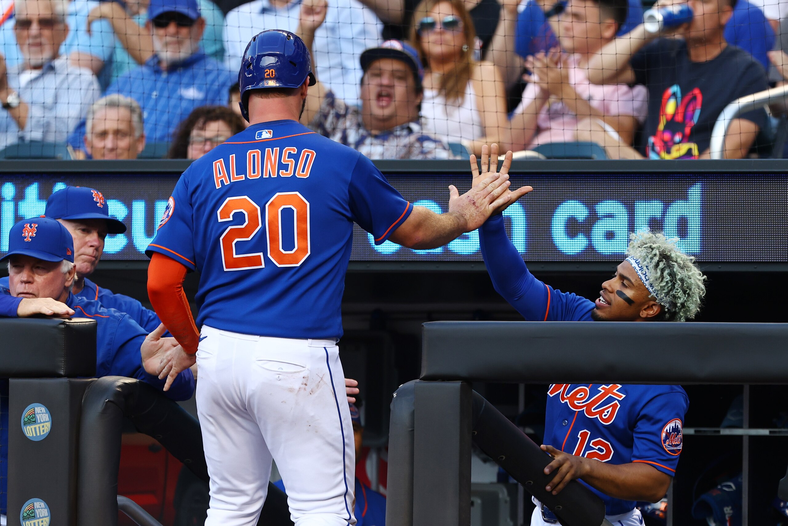 NEW YORK, NY - JUNE 14: Pete Alonso #20 of the New York Mets is congratulated by Francisco Lindor #12 after scoring on a sacrifice fly Eduardo Escobar #10 against the Milwaukee Brewers during the first inning of a game at Citi Field on June 14, 2022 in New York City. (Photo by Rich Schultz/Getty Images)