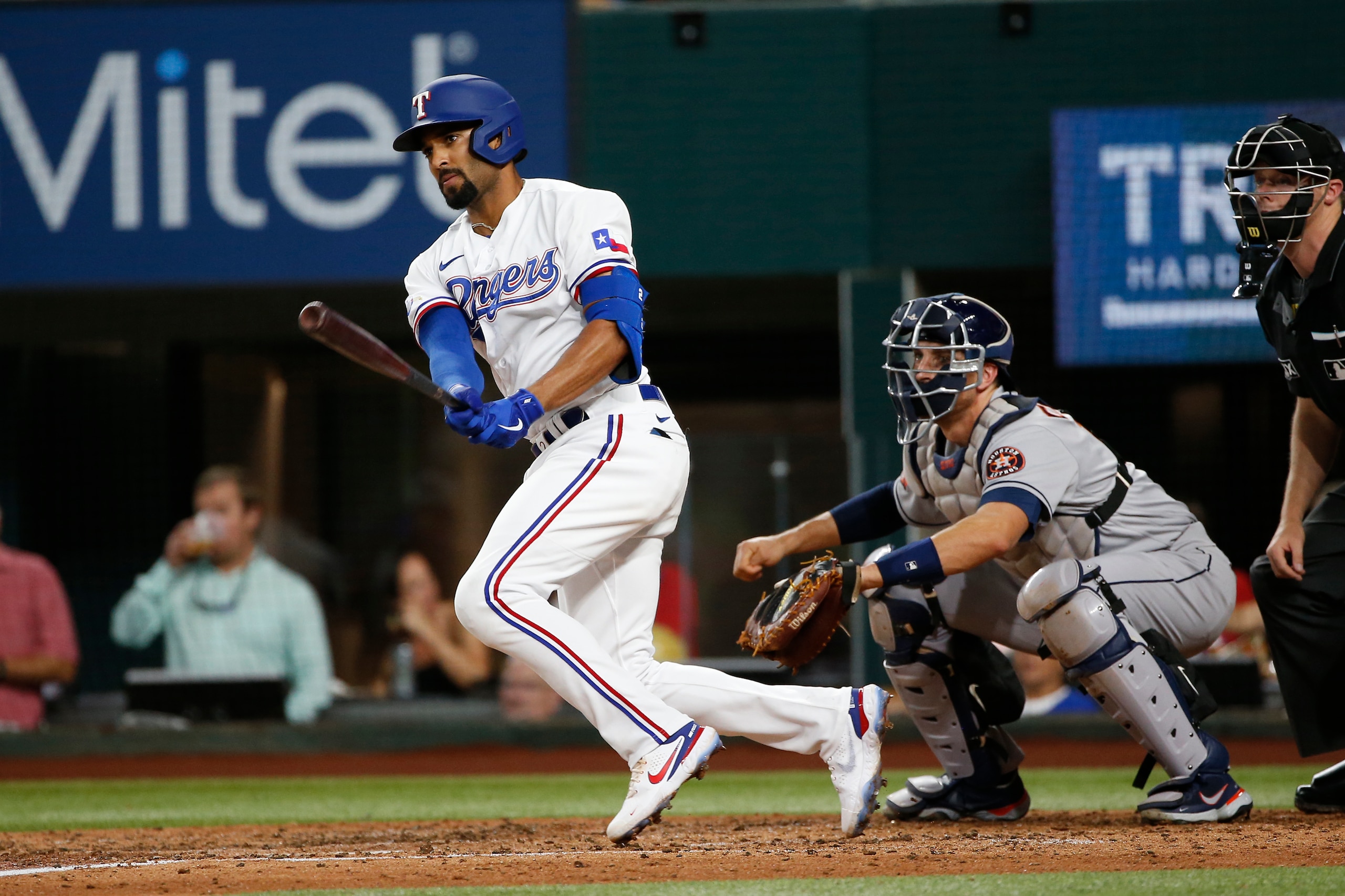 ARLINGTON, TEXAS - JUNE 14: Marcus Semien #2 of the Texas Rangers drives in a run with a single against the Houston Astros in the third inning  at Globe Life Field on June 14, 2022 in Arlington, Texas. (Photo by Tim Heitman/Getty Images)