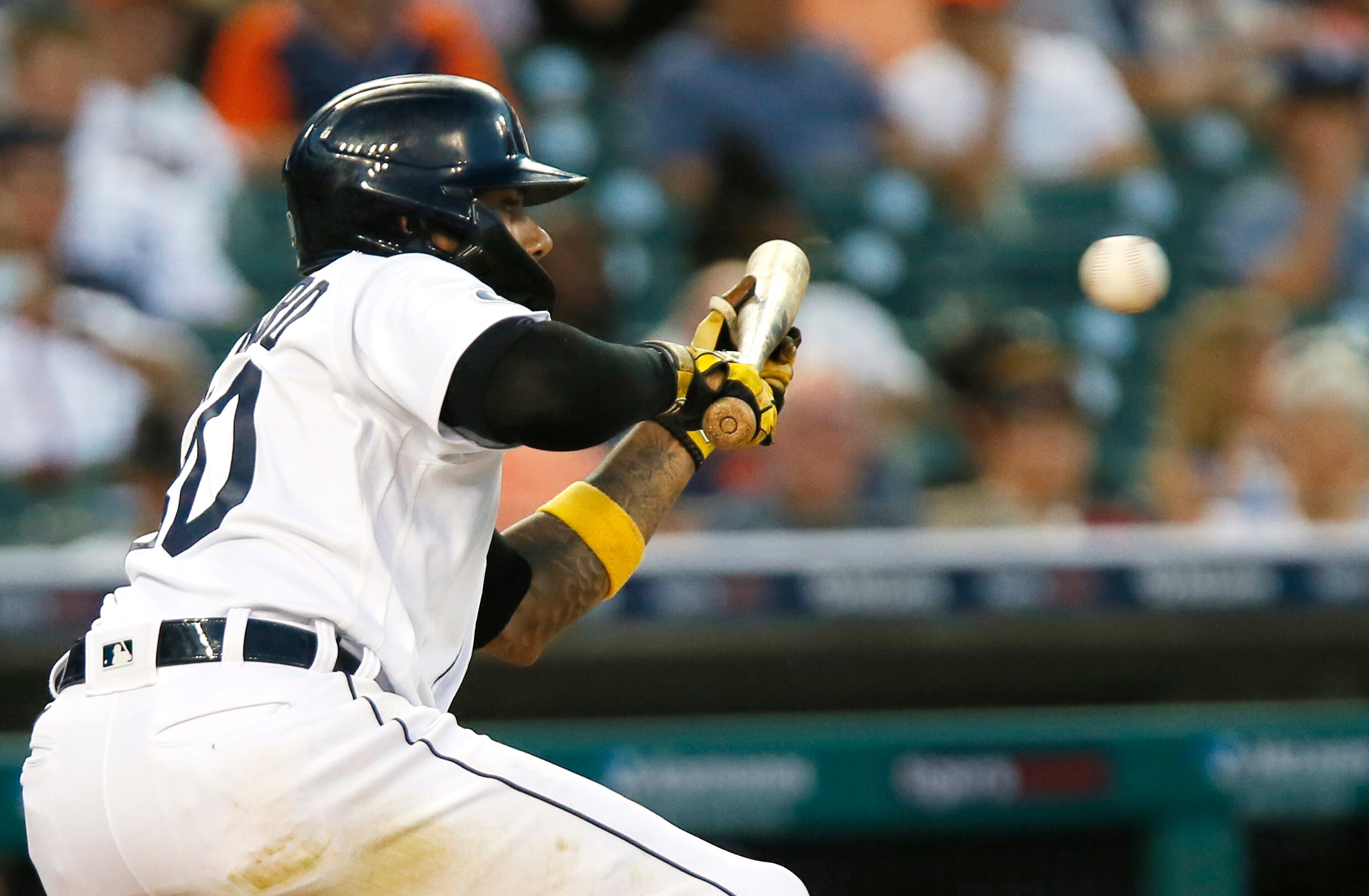 DETROIT, MI -  JUNE 16: Harold Castro #30 of the Detroit Tigers lays down a sacrifice bunt against the Texas Rangers to advance Spencer Torkelson to second base in the seventh inning at Comerica Park on June 16, 2022, in Detroit, Michigan. (Photo by Duane Burleson/Getty Images)