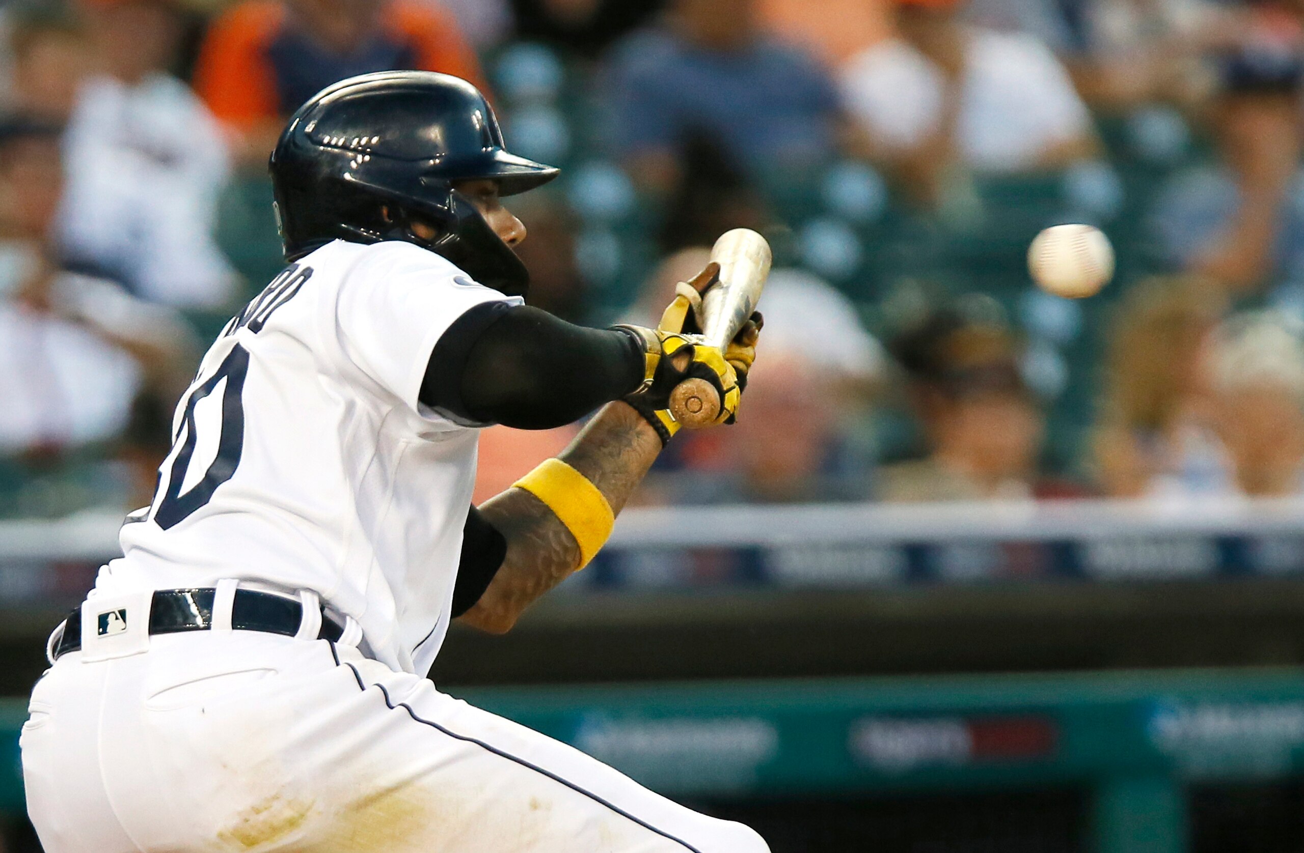 DETROIT, MI -  JUNE 16: Harold Castro #30 of the Detroit Tigers lays down a sacrifice bunt against the Texas Rangers to advance Spencer Torkelson to second base in the seventh inning at Comerica Park on June 16, 2022, in Detroit, Michigan. (Photo by Duane Burleson/Getty Images)