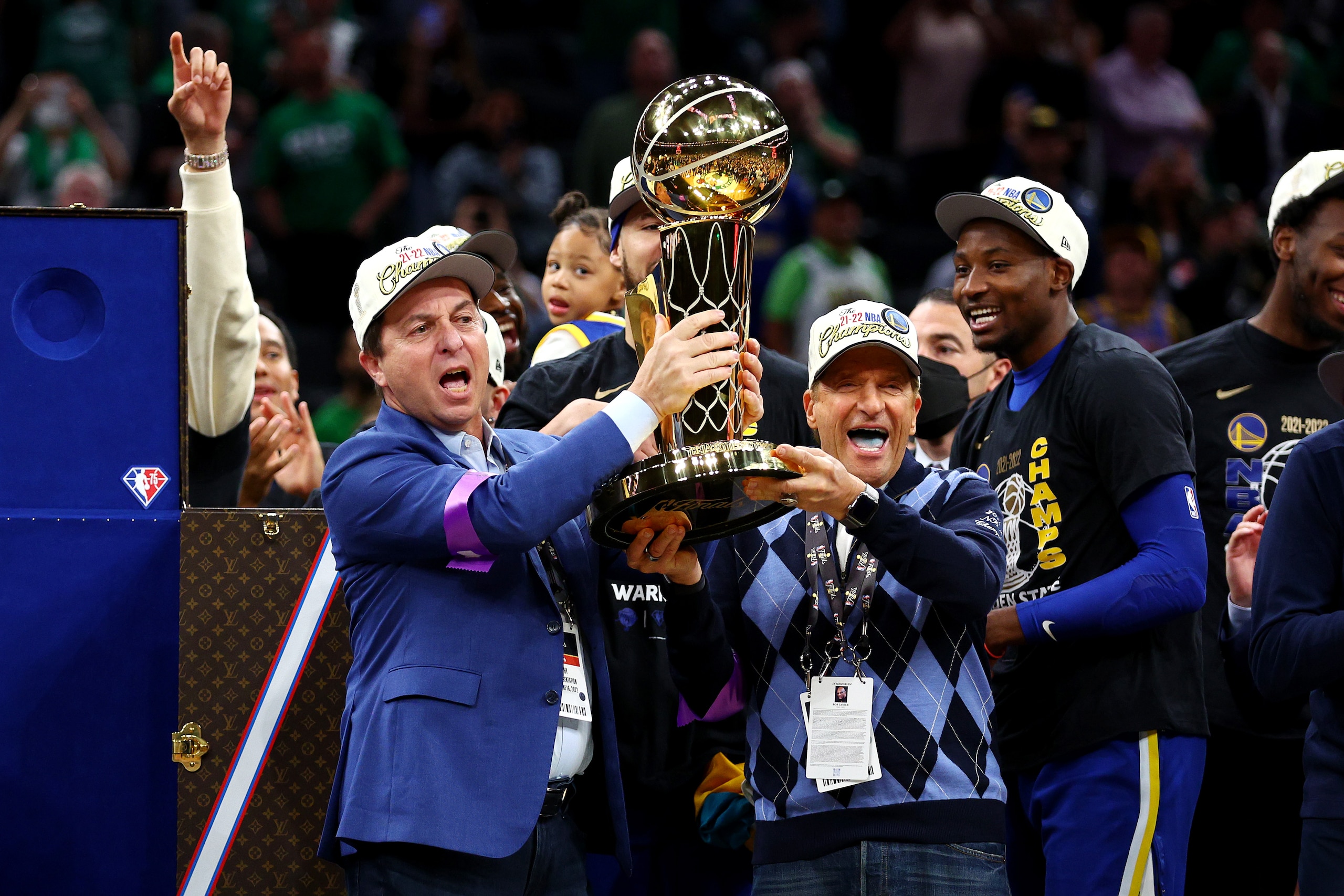 BOSTON, MASSACHUSETTS - JUNE 16: Owners Joe Lacob and Peter Guber of the Golden State Warriors raise the Larry O'Brien Championship Trophy after defeating the Boston Celtics 103-90 in Game Six of the 2022 NBA Finals at TD Garden on June 16, 2022 in Boston, Massachusetts. NOTE TO USER: User expressly acknowledges and agrees that, by downloading and/or using this photograph, User is consenting to the terms and conditions of the Getty Images License Agreement. (Photo by Elsa/Getty Images) BOSTON, MASSACHUSETTS - JUNE 16: Owners Joe Lacob and Peter Guber of the Golden State Warriors raise the Larry O'Brien Championship Trophy after defeating the Boston Celtics 103-90 in Game Six of the 2022 NBA Finals at TD Garden on June 16, 2022 in Boston, Massachusetts. NOTE TO USER: User expressly acknowledges and agrees that, by downloading and/or using this photograph, User is consenting to the terms and conditions of the Getty Images License Agreement. (Photo by Elsa/Getty Images)