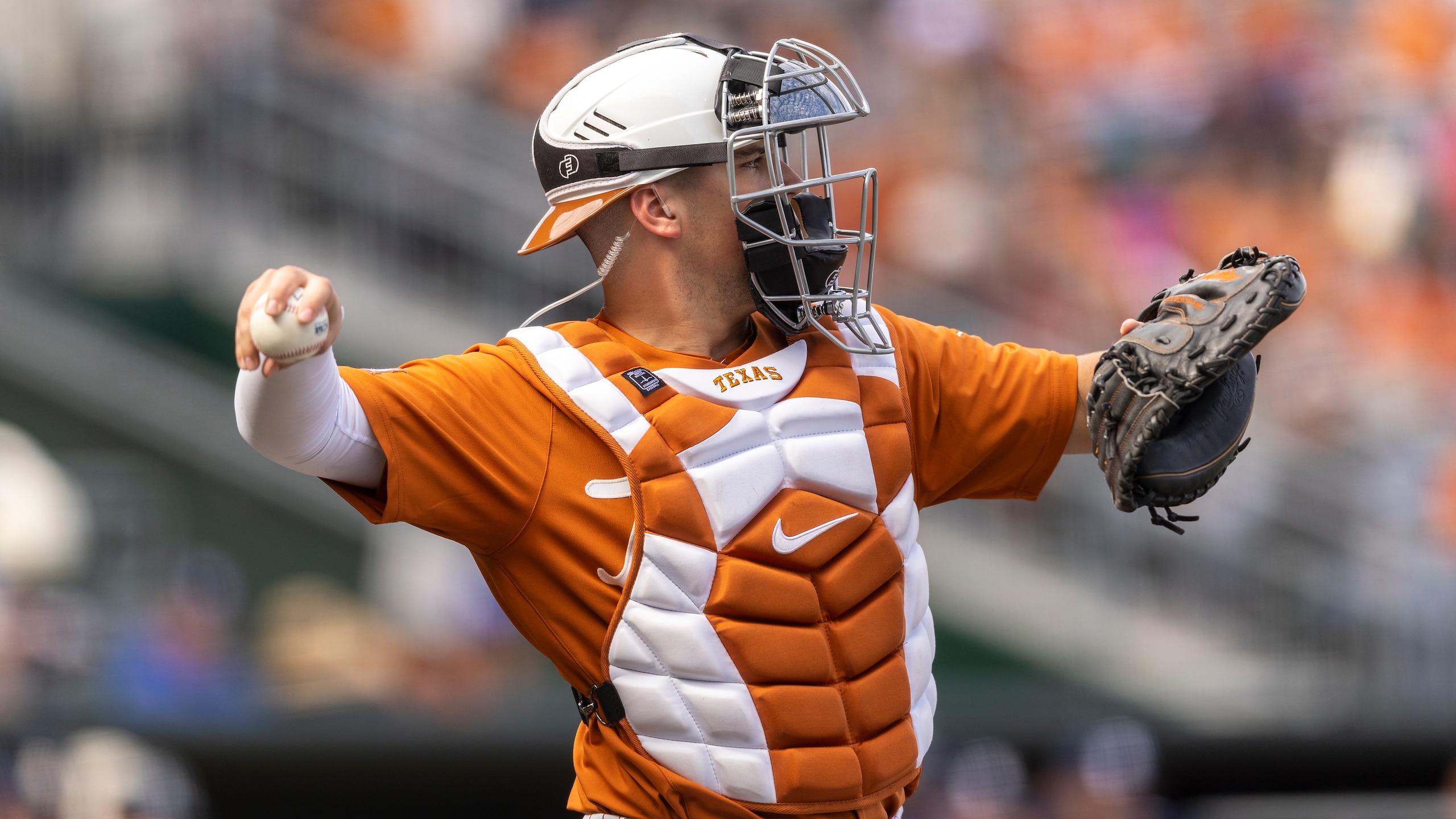 Texas catcher Silas Ardoin warms up against Rice during an NCAA baseball game on Sunday, Feb. 20, 2022, in Austin, Texas. (AP Photo/Stephen Spillman)