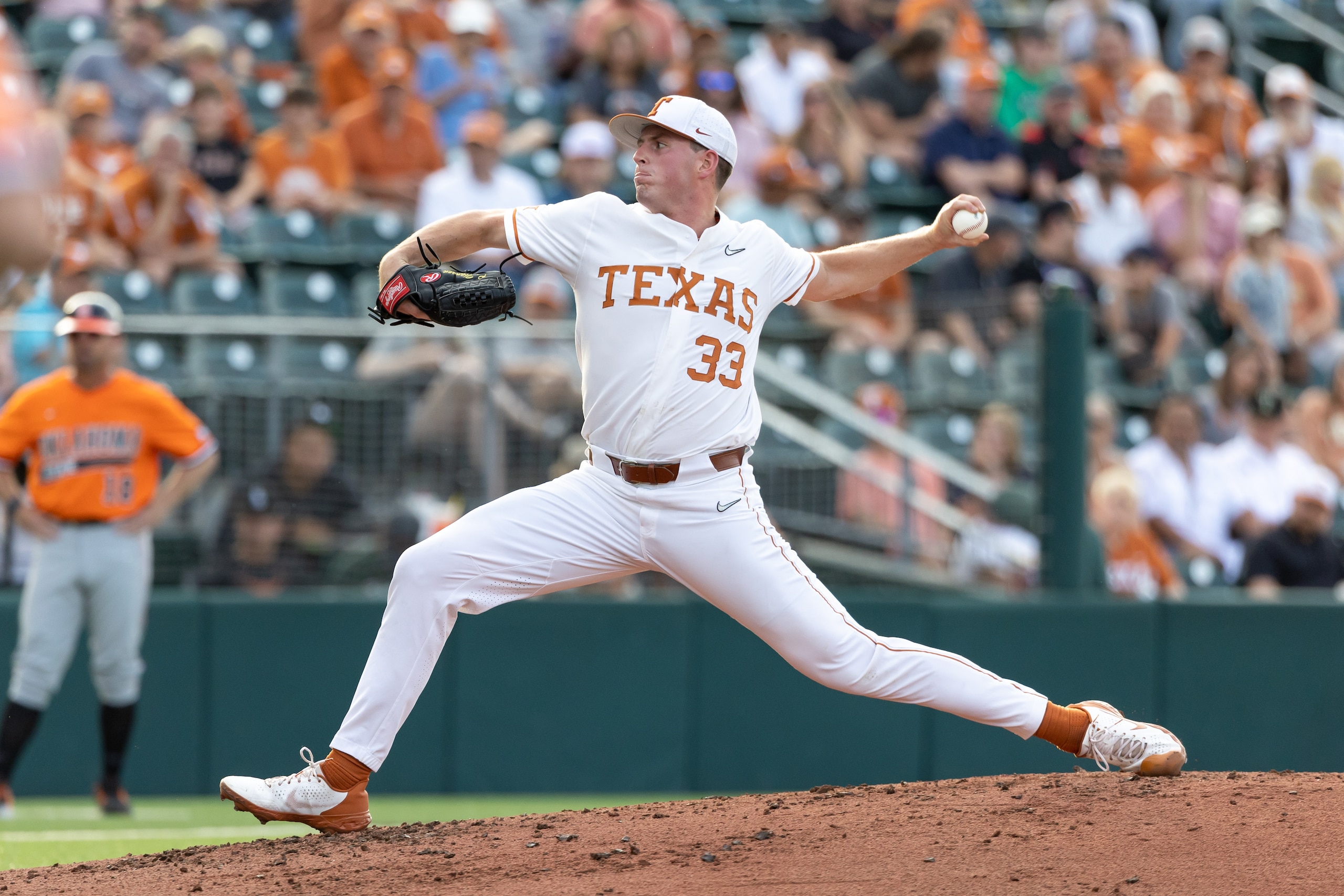 AUSTIN, TX - APRIL 29: Texas Longhorns pitcher Pete Hansen (33) stretches out while throwing a pitch during the game between Texas Longhorns and Oklahoma State Cowboys on April 29, 2022, at UFCU Disch-Falk Field in Austin, TX. (Photo by David Buono/Icon Sportswire via Getty Images)
