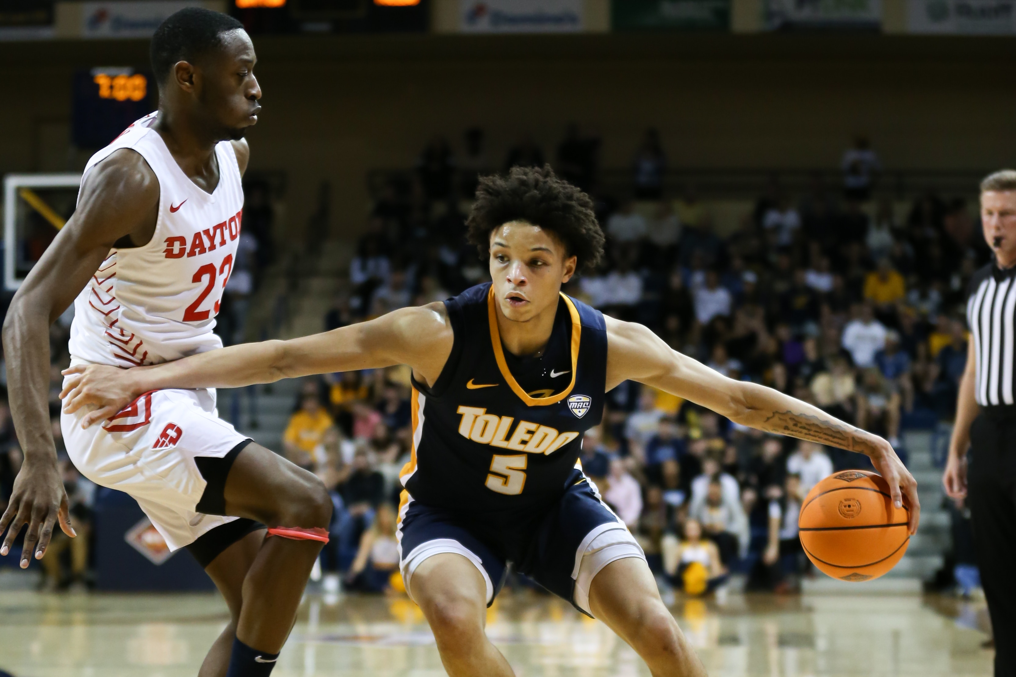 TOLEDO, OH - MARCH 16:  Toledo Rockets guard Ryan Rollins (5) drives to the basket past Dayton Flyers forward R.J. Blakney (23) during a first round basketball game of the National Invitational Tournament between the Dayton Flyers and the Toledo Rockets on March 16, 2022 at Savage Arena in Toledo, Ohio.  (Photo by Scott W. Grau/Icon Sportswire via Getty Images)