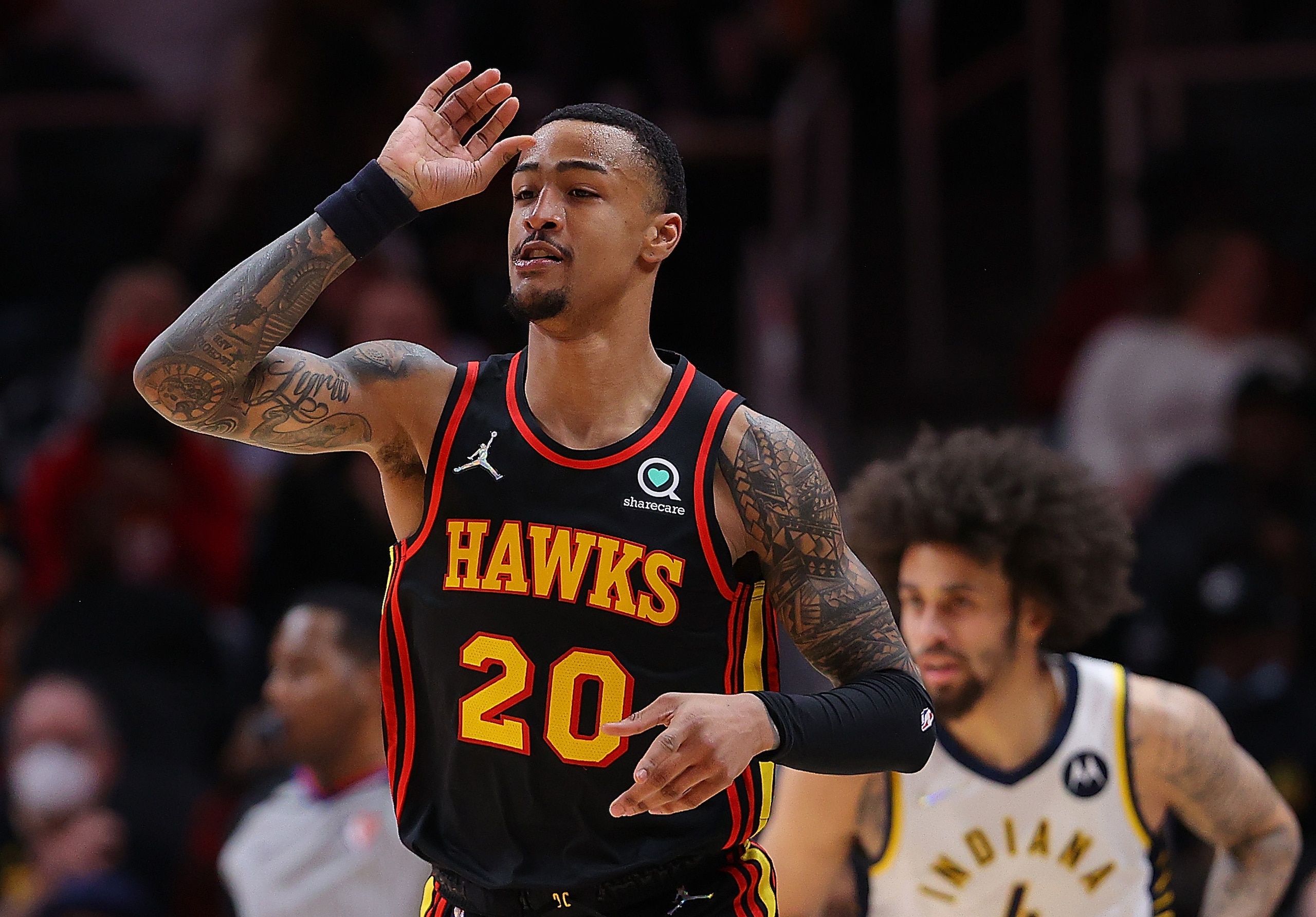 ATLANTA, GEORGIA - FEBRUARY 08:  John Collins #20 of the Atlanta Hawks reacts after hitting a three-point basket against the Indiana Pacers during the first half at State Farm Arena on February 08, 2022 in Atlanta, Georgia.  NOTE TO USER: User expressly acknowledges and agrees that, by downloading and or using this photograph, User is consenting to the terms and conditions of the Getty Images License Agreement.  (Photo by Kevin C. Cox/Getty Images)