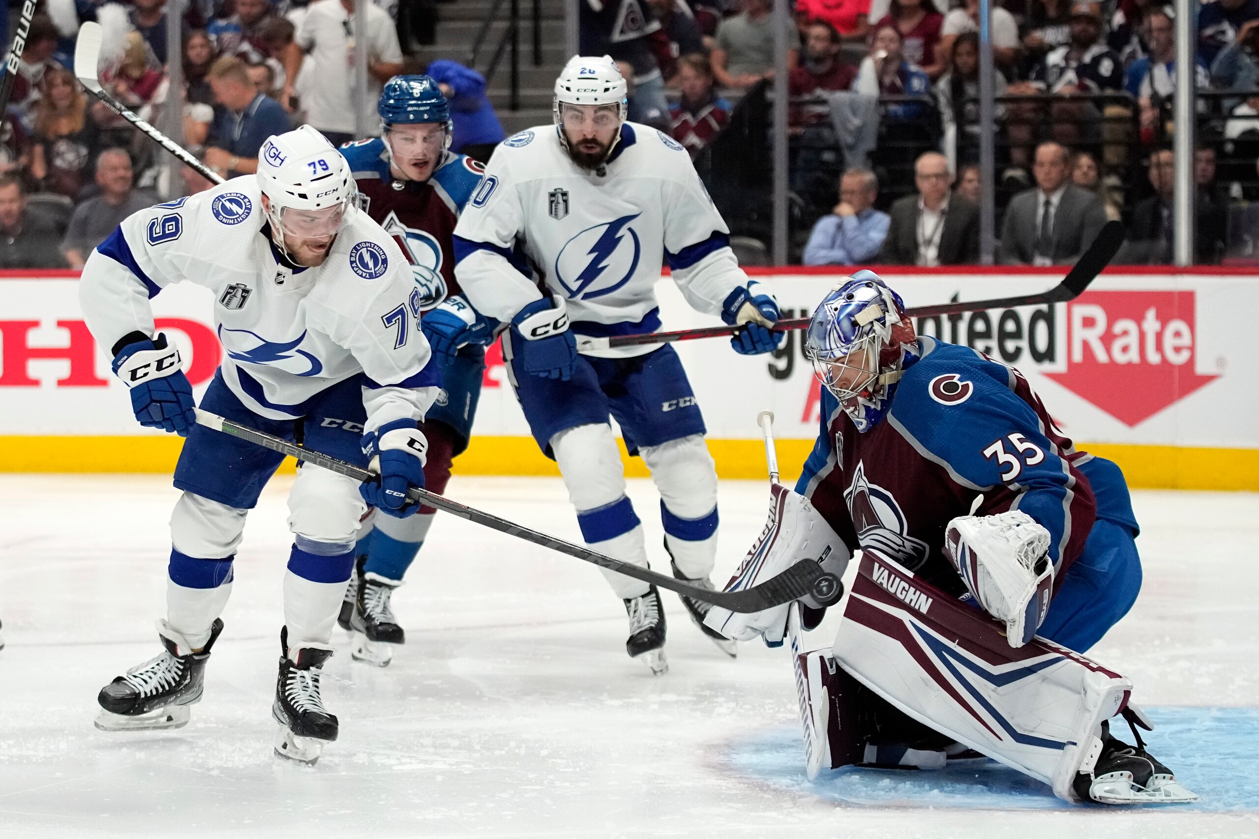 Colorado Avalanche goaltender Darcy Kuemper (35) stops a shot from Tampa Bay Lightning center Ross Colton (79) during the third period of Game 1 of the NHL hockey Stanley Cup Final on Wednesday, June 15, 2022, in Denver. (AP Photo/John Locher)