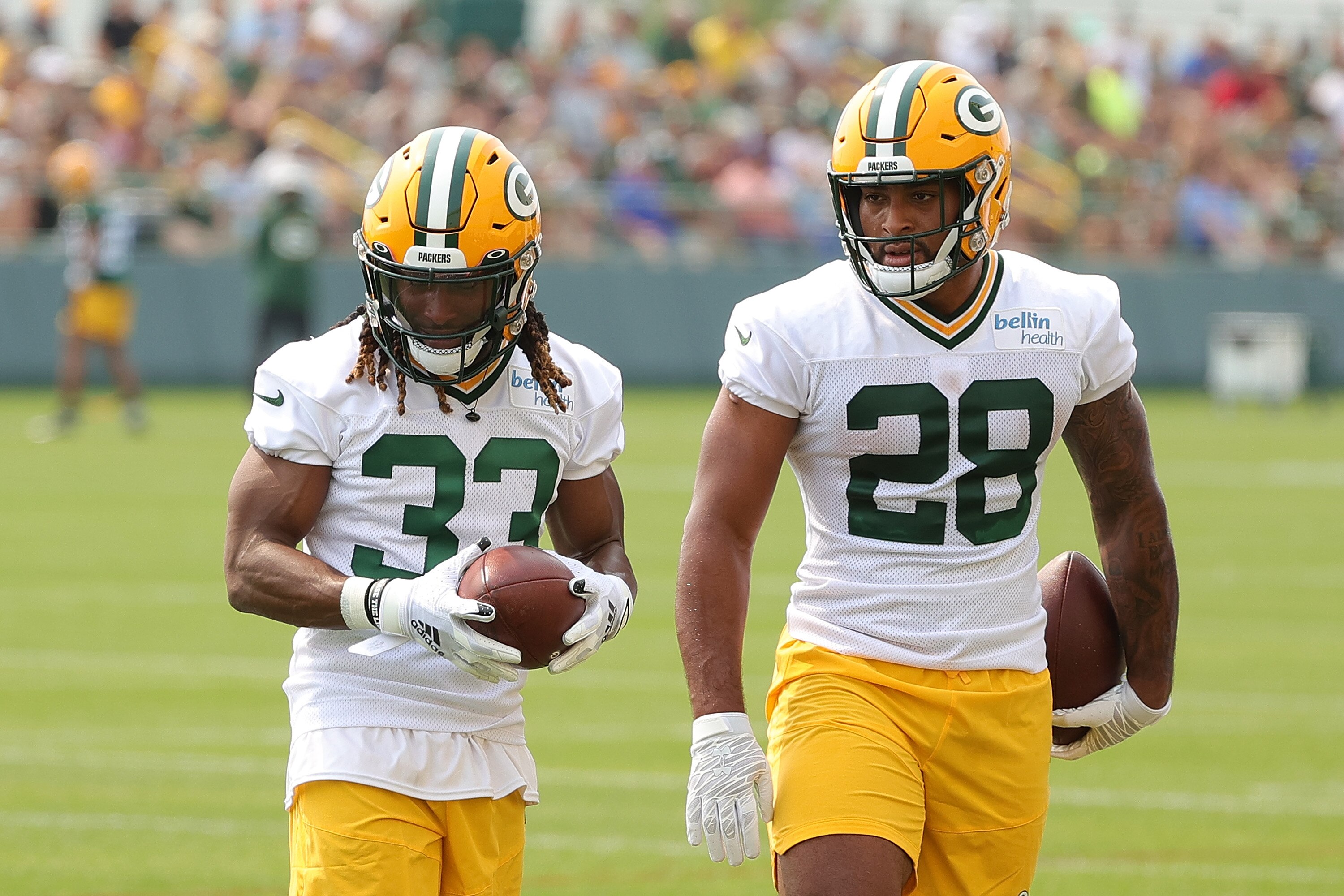 ASHWAUBENON, WISCONSIN - JULY 28:  Aaron jones #33 and AJ Dillon #28 of the Green Bay Packers works out during training camp at Ray Nitschke Field on July 28, 2021 in Ashwaubenon, Wisconsin. (Photo by Stacy Revere/Getty Images)