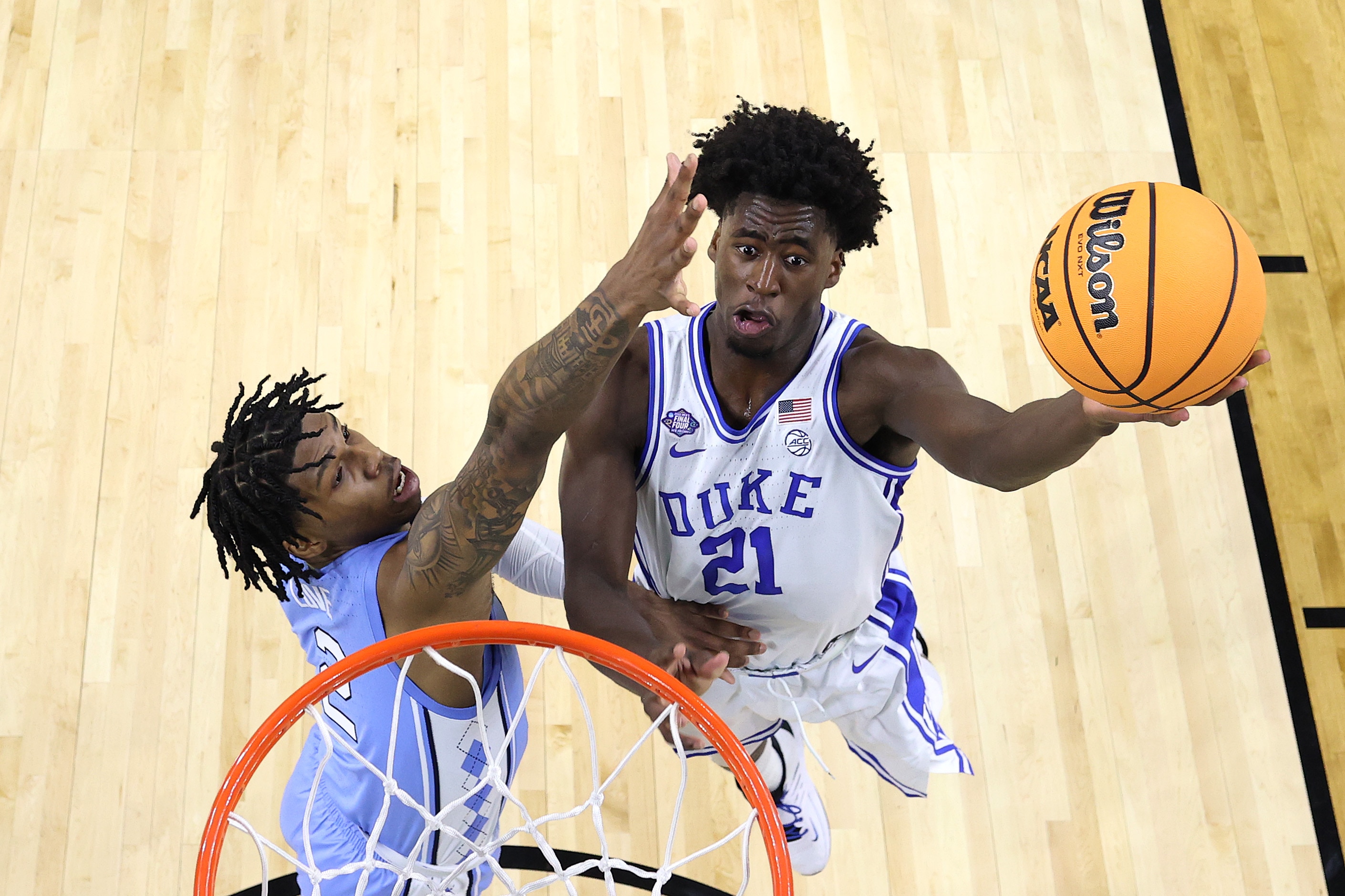 NEW ORLEANS, LOUISIANA - APRIL 02: AJ Griffin #21 of the Duke Blue Devils drives to the basket against Caleb Love #2 of the North Carolina Tar Heels during the first half in the semifinal game of the 2022 NCAA Men's Basketball Tournament Final Four at Caesars Superdome on April 02, 2022 in New Orleans, Louisiana. (Photo by Handout/NCAA Photos via Getty Images)