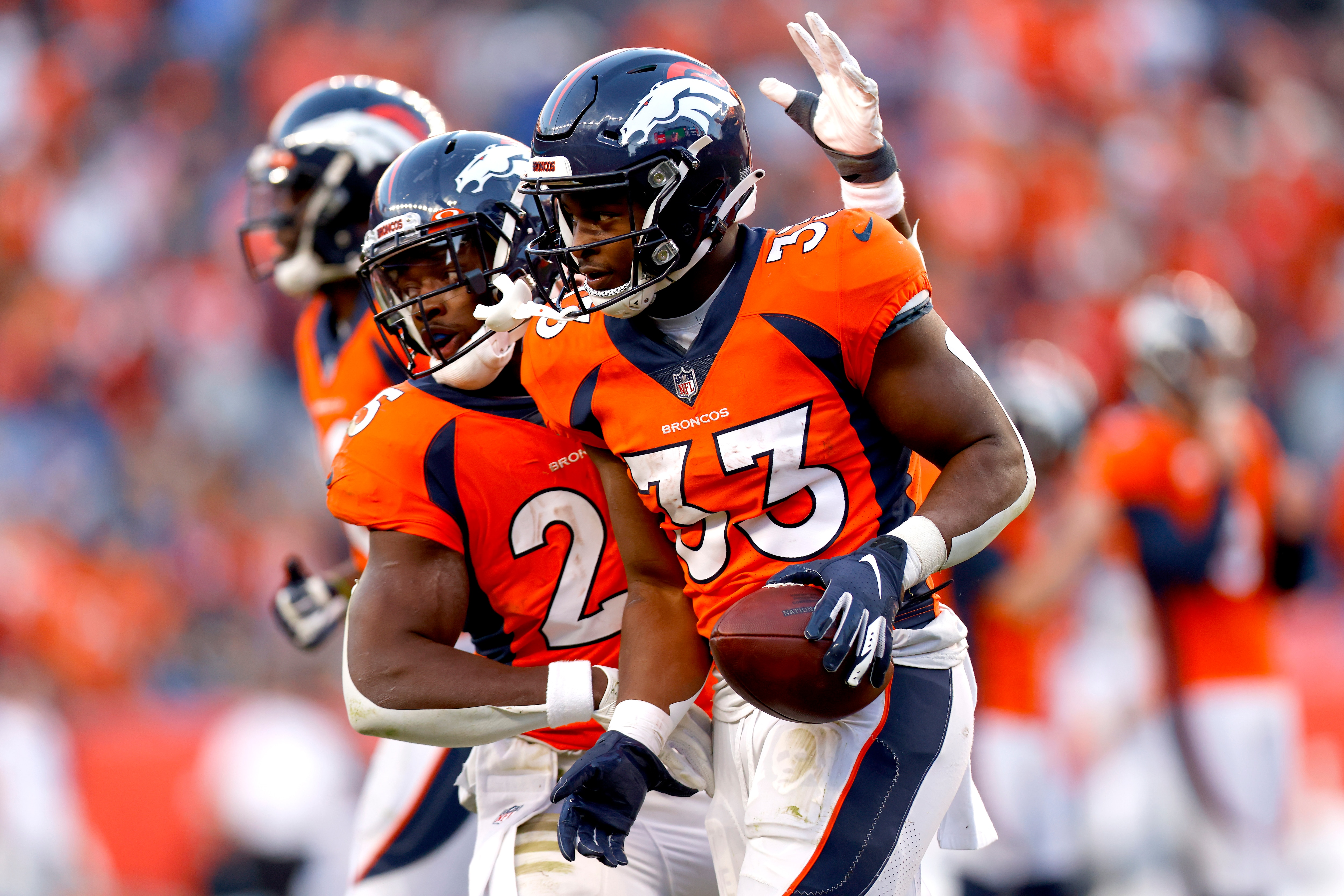 DENVER, COLORADO - DECEMBER 12: Javonte Williams #33 of the Denver Broncos is congratulated on his receiving touchdown by Melvin Gordon III #25 during the third quarter against the Detroit Lions at Empower Field At Mile High on December 12, 2021 in Denver, Colorado. (Photo by Justin Edmonds/Getty Images)