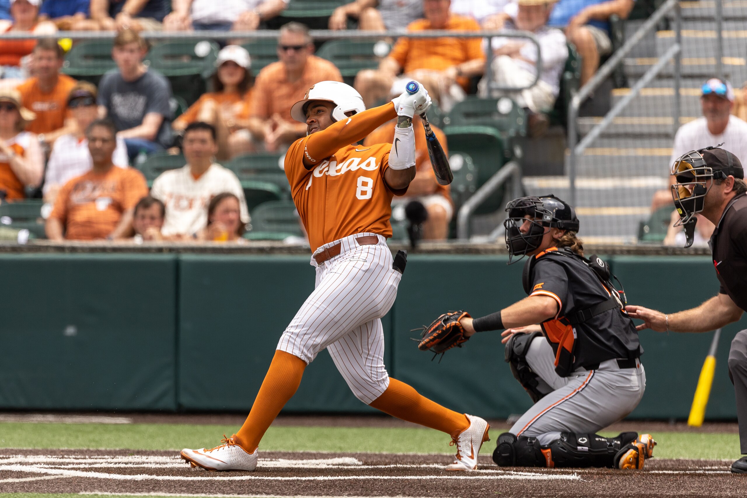 AUSTIN, TX - MAY 01: Texas Longhorns infielder Dylan Campbell (8) hits a solo home run during the second inning of the game between Texas Longhorns and Oklahoma State Cowboys on May 1, 2022, at UFCU Disch-Falk Field in Austin, TX. (Photo by David Buono/Icon Sportswire via Getty Images)