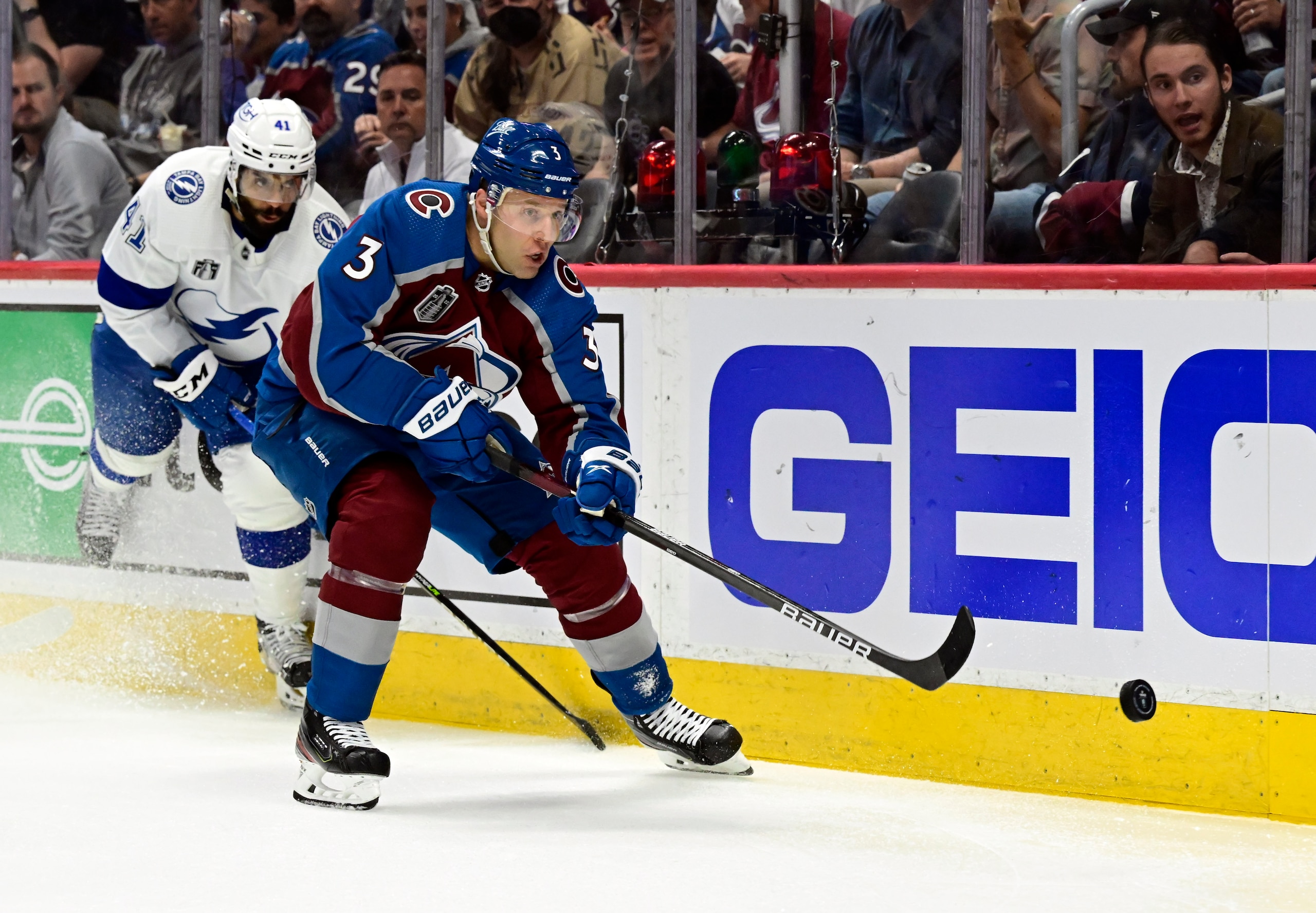 DENVER, CO - JUNE 15: Jack Johnson (3) of the Colorado Avalanche sends the puck up the boards with pressure from Pierre-Edouard Bellemare (41) of the Tampa Bay Lightning during the second period of Game 1 in the 2022 NHL Stanley Cup Finals as the Colorado Avalanche play against the Tampa Bay Lightning at Ball Arena on Wednesday, June 15, 2022. (Photo by Andy Cross/MediaNews Group/The Denver Post via Getty Images)
