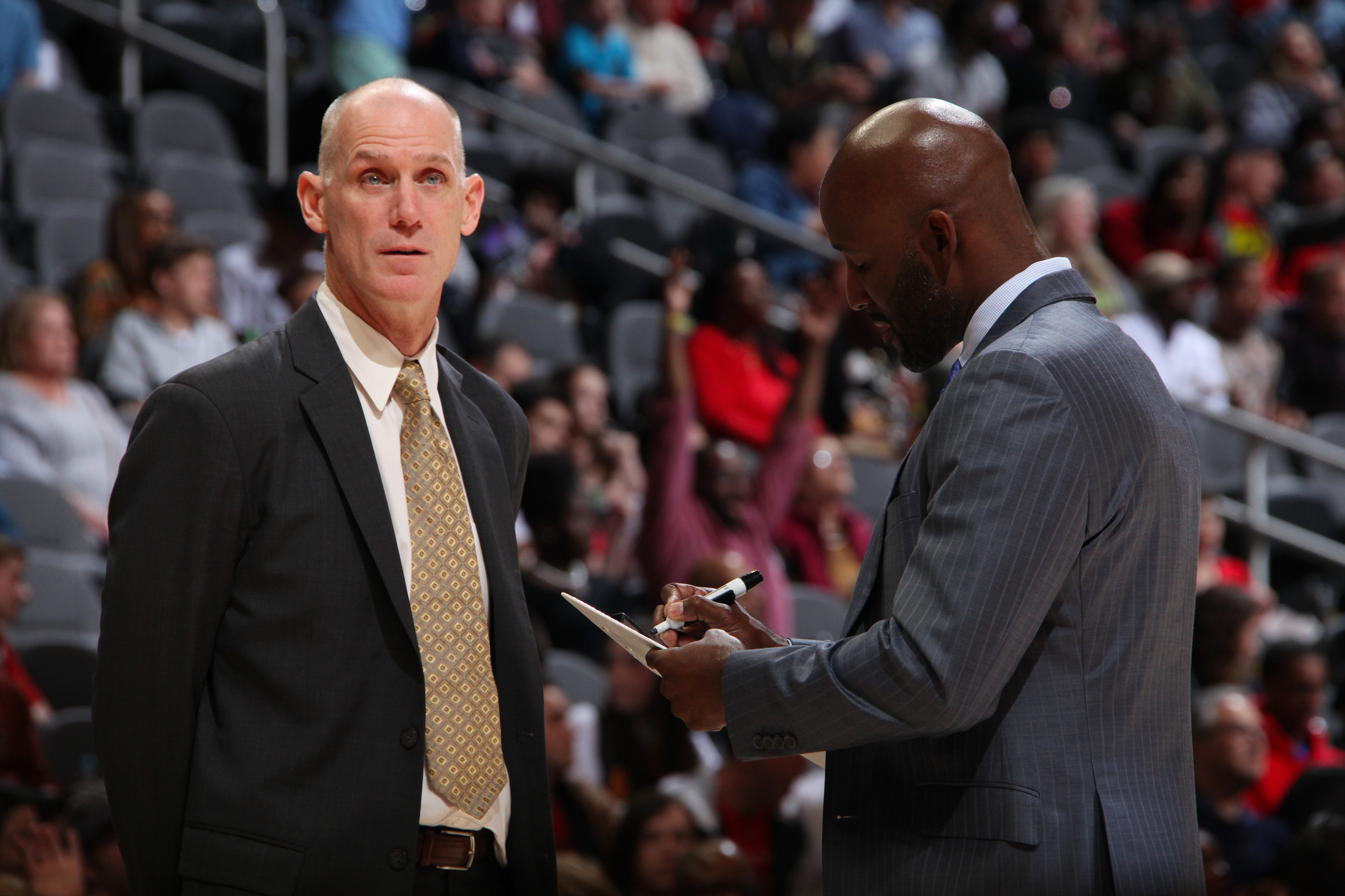 ATLANTA, GA - MARCH 29: Assistant Coach Chris Jent and Head Coach Lloyd Pierce of the Atlanta Hawks speak during the game against the Portland Trail Blazers on March 29, 2019 at State Farm Arena in Atlanta, Georgia.  NOTE TO USER: User expressly acknowledges and agrees that, by downloading and/or using this Photograph, user is consenting to the terms and conditions of the Getty Images License Agreement. Mandatory Copyright Notice: Copyright 2019 NBAE (Photo by Jasear Thompson/NBAE via Getty Images)
