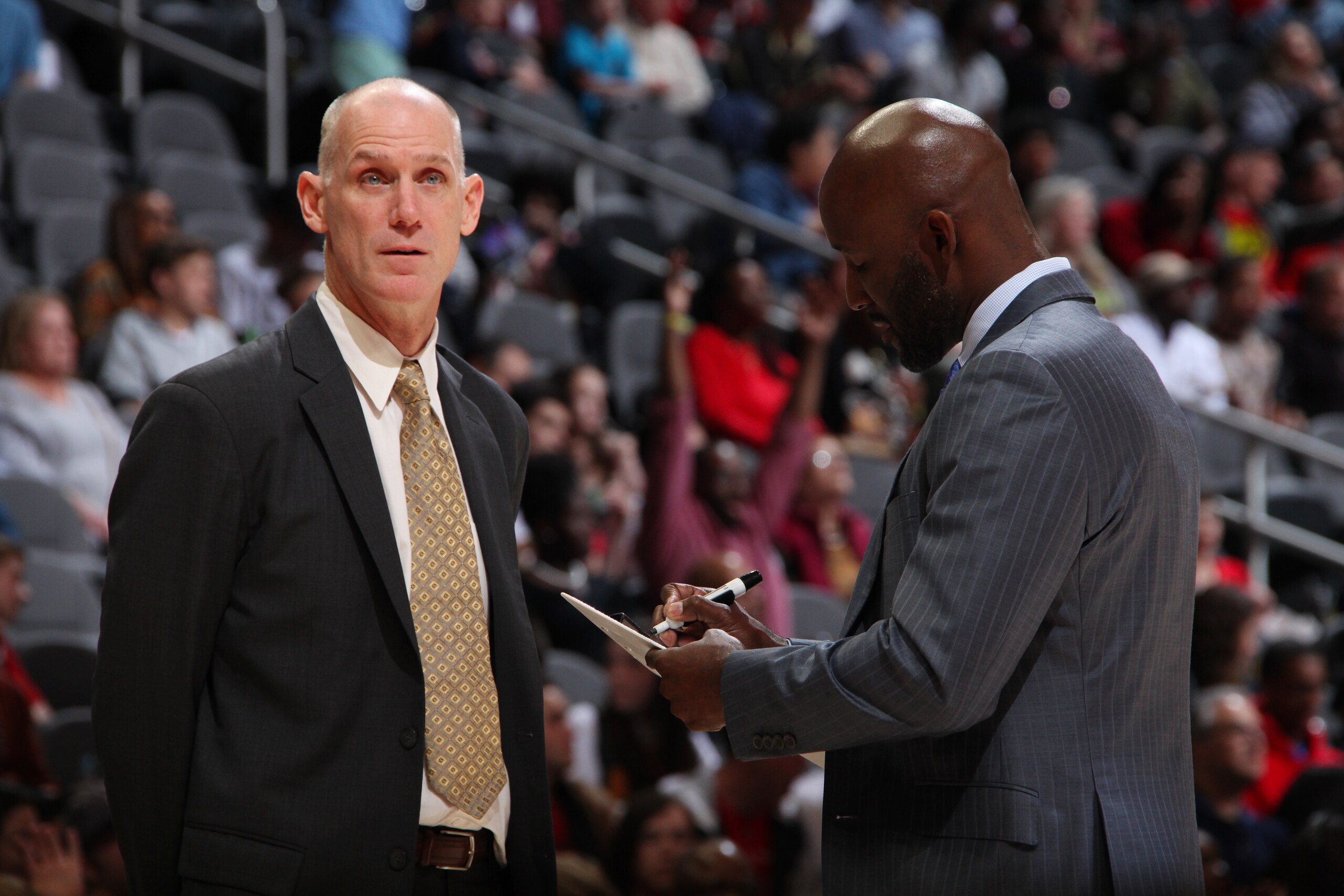 ATLANTA, GA - MARCH 29: Assistant Coach Chris Jent and Head Coach Lloyd Pierce of the Atlanta Hawks speak during the game against the Portland Trail Blazers on March 29, 2019 at State Farm Arena in Atlanta, Georgia.  NOTE TO USER: User expressly acknowledges and agrees that, by downloading and/or using this Photograph, user is consenting to the terms and conditions of the Getty Images License Agreement. Mandatory Copyright Notice: Copyright 2019 NBAE (Photo by Jasear Thompson/NBAE via Getty Images)
