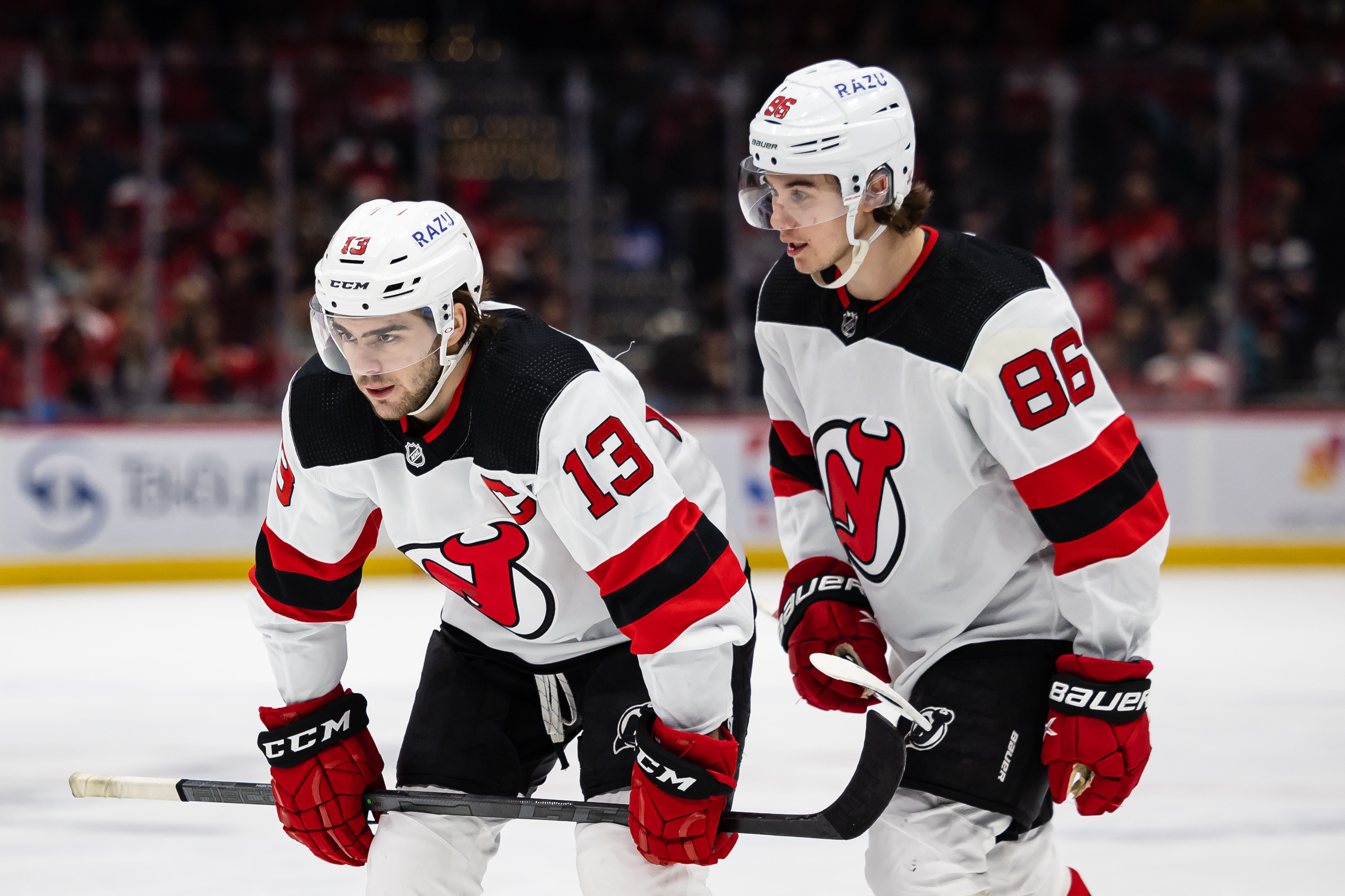 WASHINGTON, DC - March 26: Nico Hischier #13 and Jack Hughes #86 of the New Jersey Devils prepare for a face-off against the Washington Capitals during the first period of the game at Capital One Arena on March 26, 2022 in Washington, DC. (Photo by Scott Taetsch/Getty Images)