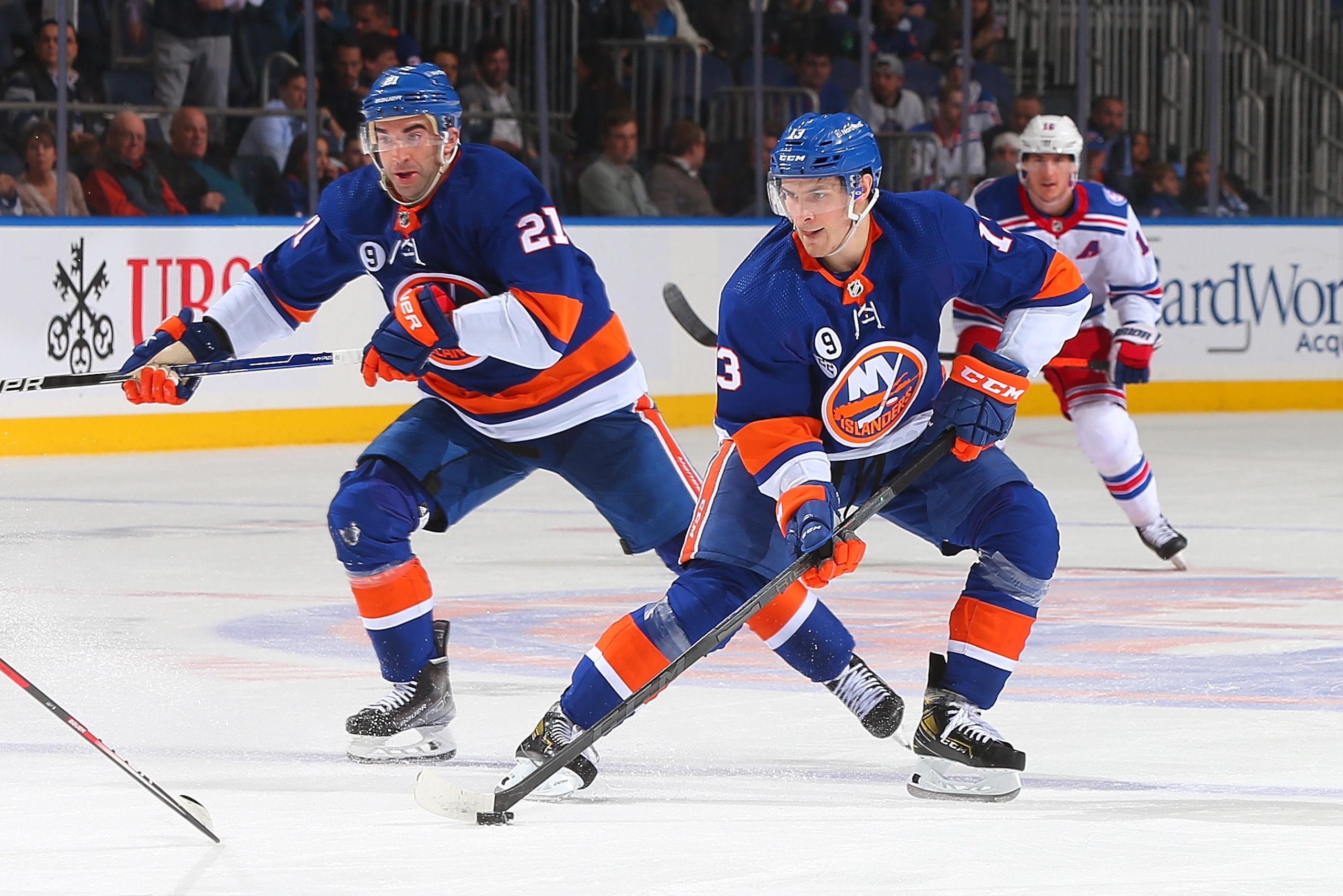 ELMONT, NEW YORK - APRIL 21: Mathew Barzal #13 and Kyle Palmieri #21 of the New York Islanders in action against the New York Rangers at UBS Arena on April 21, 2022 in Elmont, New York. New York Rangers defeated the New York Rangers 6-3. (Photo by Mike Stobe/NHLI via Getty Images)