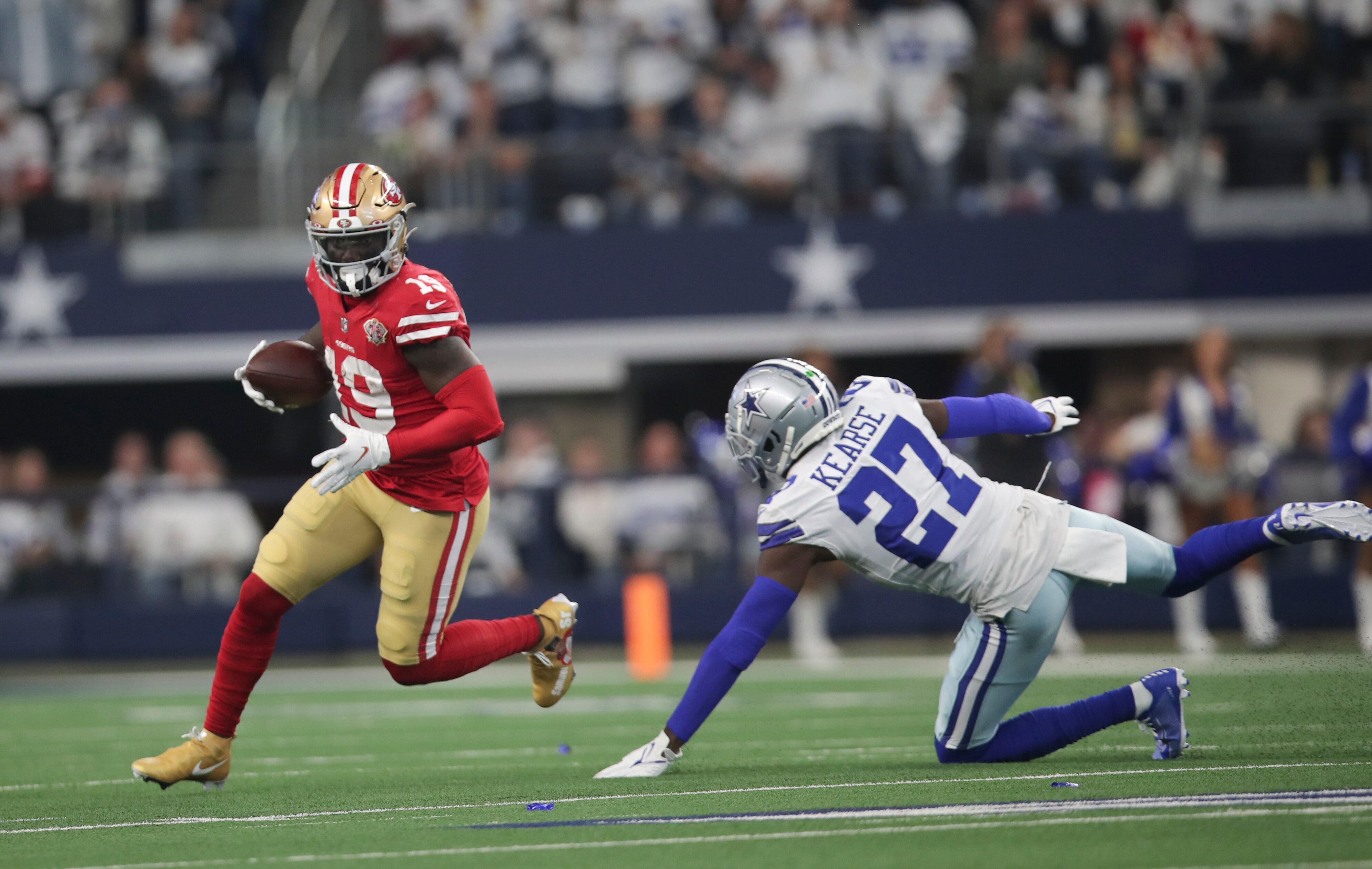 ARLINGTON, TX - JANUARY 16: Deebo Samuel #19 of the San Francisco 49ers runs after making a catch during the NFC Wild Card Playoff game against the Dallas Cowboys at AT&T Stadium on January 16, 2022 in Arlington, Texas. The 49ers defeated the Cowboys 23-17. (Photo by Michael Zagaris/San Francisco 49ers/Getty Images)