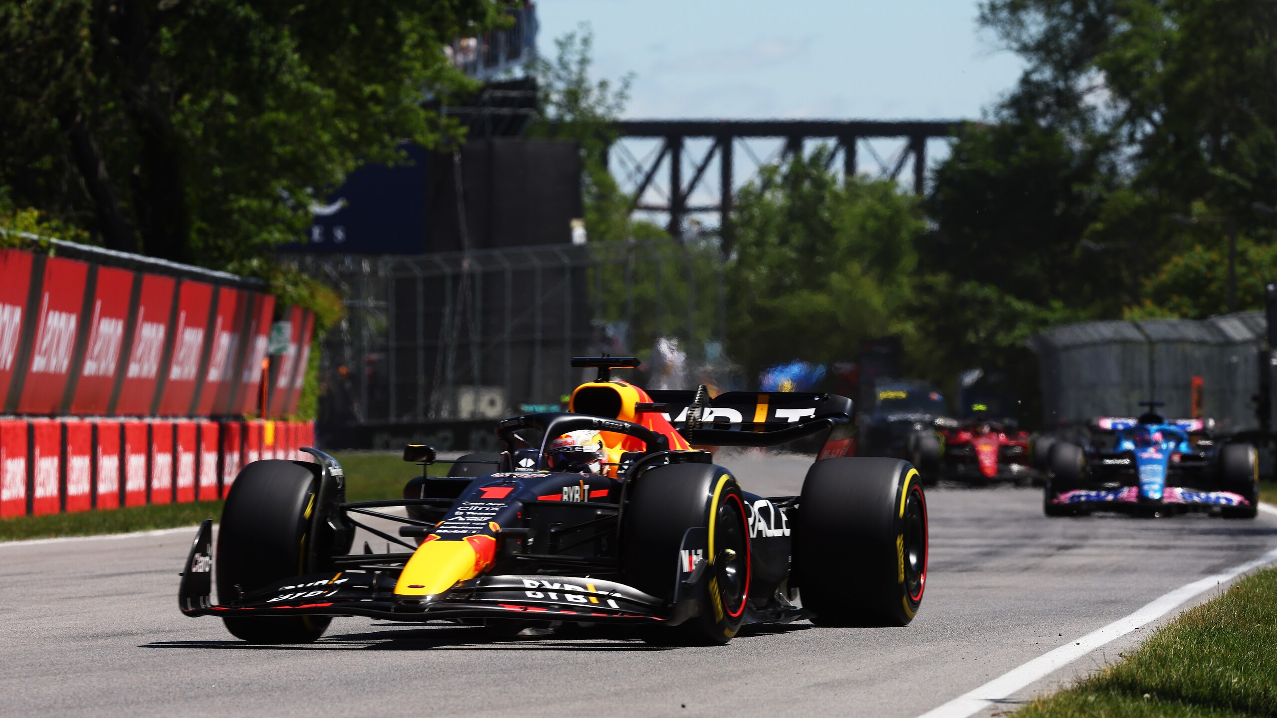 MONTREAL, QUEBEC - JUNE 19: Max Verstappen of the Netherlands driving the (1) Oracle Red Bull Racing RB18 leads Fernando Alonso of Spain driving the (14) Alpine F1 A522 Renault during the F1 Grand Prix of Canada at Circuit Gilles Villeneuve on June 19, 2022 in Montreal, Quebec. (Photo by Lars Baron - Formula 1/Formula 1 via Getty Images)