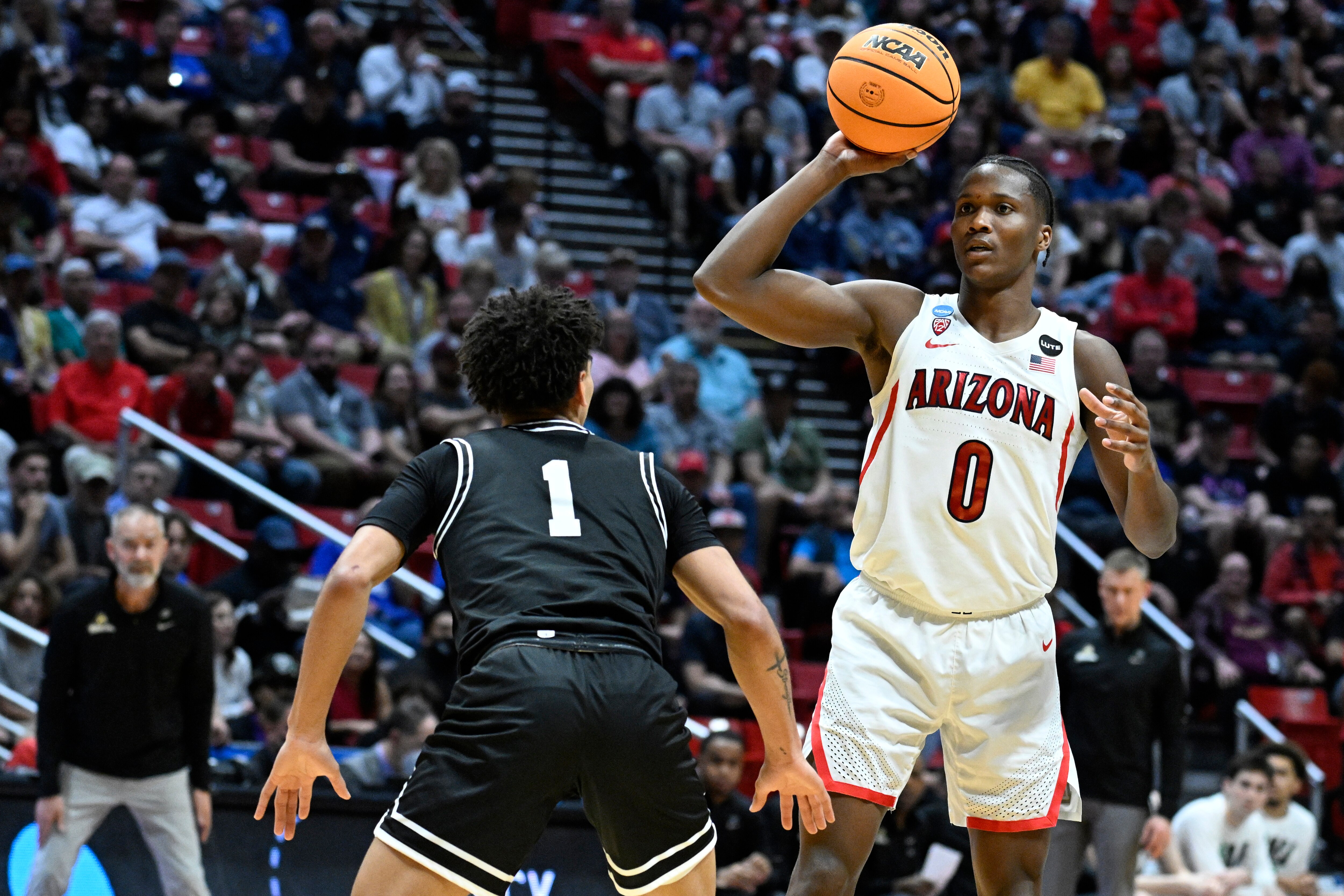 Arizona guard Bennedict Mathurin (0) looks to pass around Wright State guard Trey Calvin (1) during the second half of a first-round NCAA college basketball tournament game, Friday, March 18, 2022, in San Diego. Arizona won 87-70. (AP Photo/Denis Poroy)