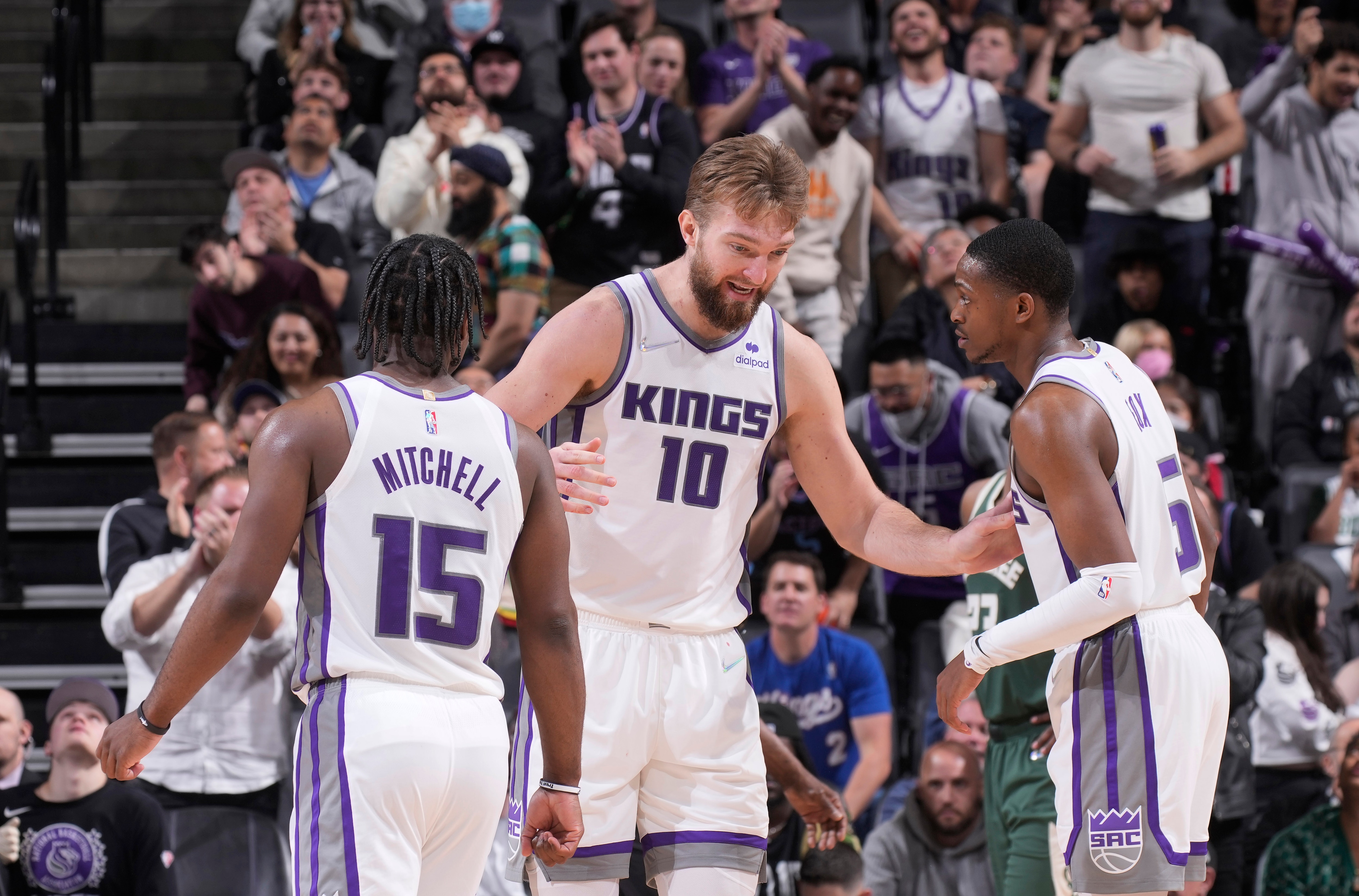 SACRAMENTO, CA - MARCH 16: Domantas Sabonis #10 of the Sacramento Kings talks to teammates Davion Mitchell #15 and De'Aaron Fox #5 during the game against the Milwaukee Bucks on March 16, 2022 at Golden 1 Center in Sacramento, California. NOTE TO USER: User expressly acknowledges and agrees that, by downloading and or using this photograph, User is consenting to the terms and conditions of the Getty Images Agreement. Mandatory Copyright Notice: Copyright 2022 NBAE (Photo by Rocky Widner/NBAE via Getty Images)