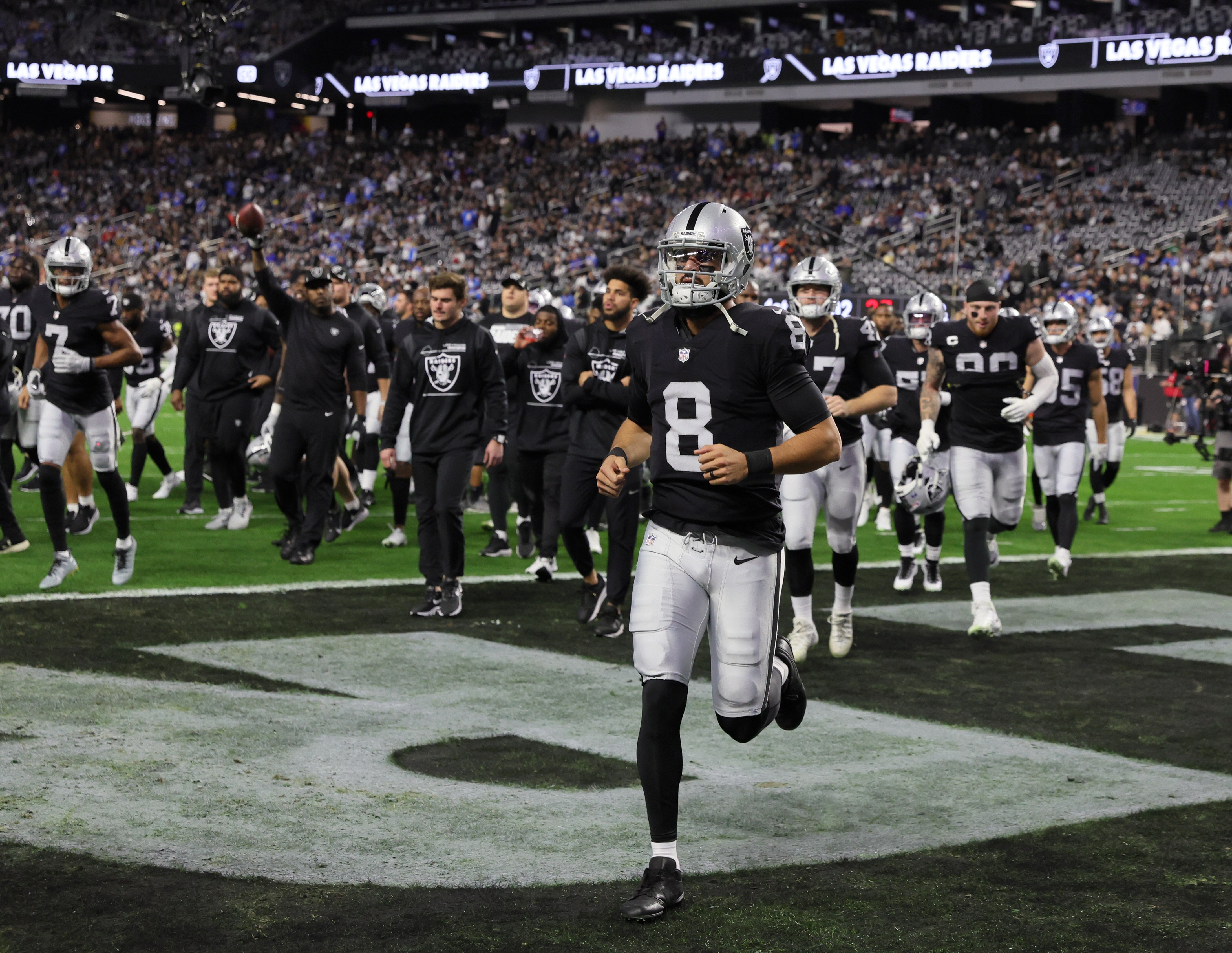 LAS VEGAS, NEVADA - JANUARY 09:  Quarterback Marcus Mariota #8 of the Las Vegas Raiders runs off the field after warmups before a game against the Los Angeles Chargers at Allegiant Stadium on January 9, 2022 in Las Vegas, Nevada. The Raiders defeated the Chargers 35-32 in overtime.  (Photo by Ethan Miller/Getty Images)