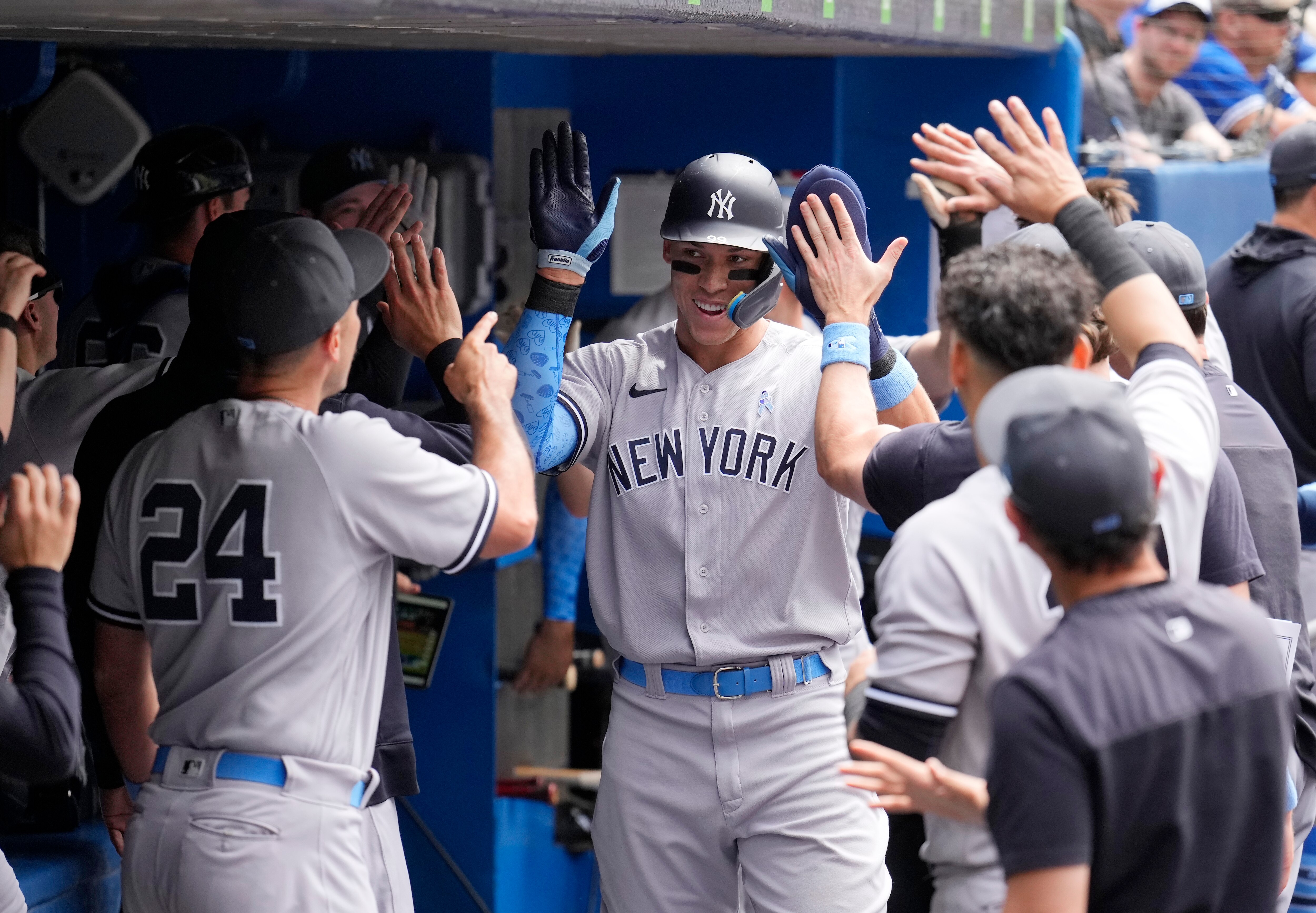 TORONTO, ON - JUNE 19: Aaron Judge #99 of the New York Yankees celebrates scoring in the dugout against the Toronto Blue Jays in the fifth inning during their MLB game at the Rogers Centre on June 19, 2022 in Toronto, Ontario, Canada. (Photo by Mark Blinch/Getty Images)