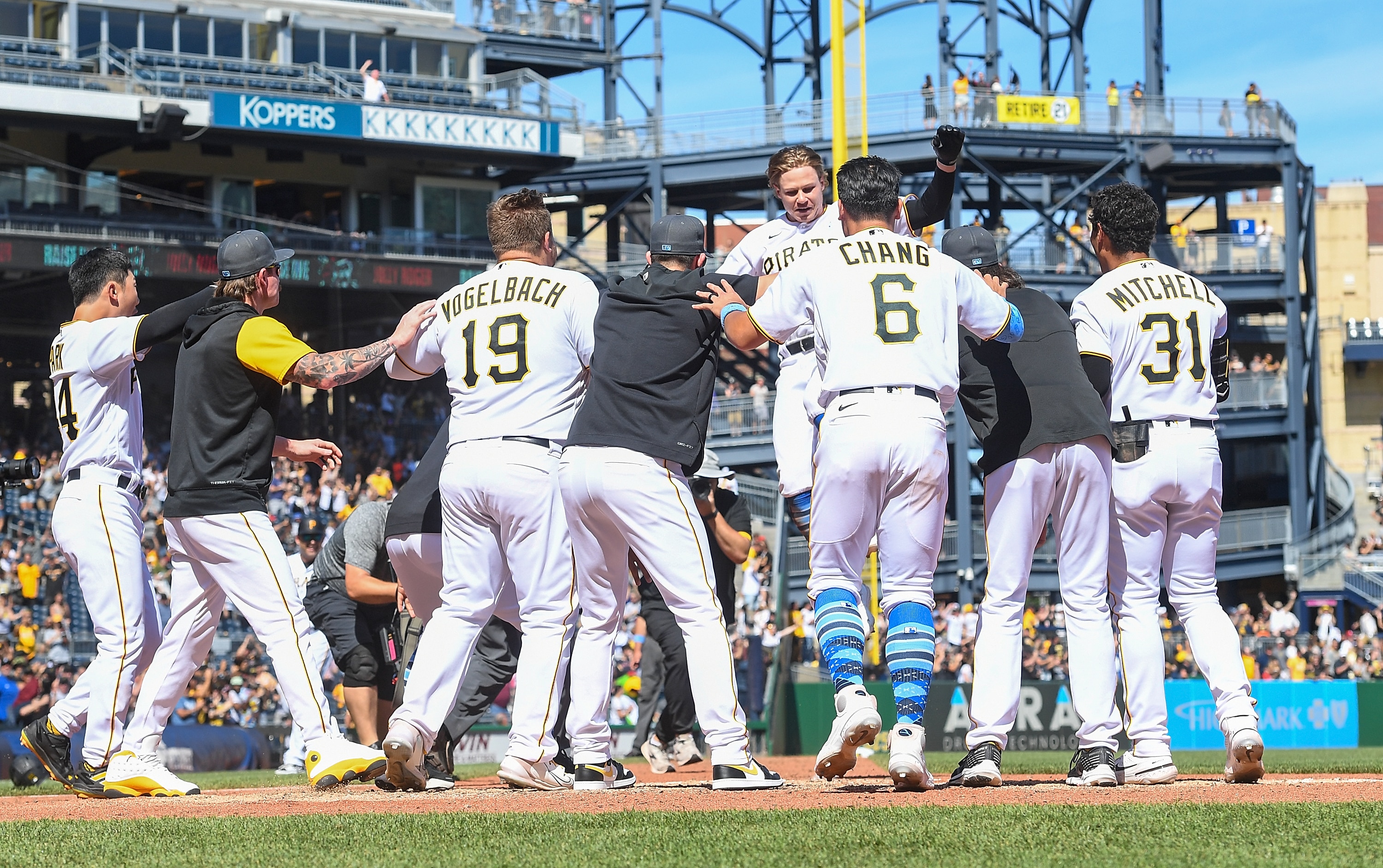 PITTSBURGH, PA - JUNE 19: Jack Suwinski #65 of the Pittsburgh Pirates is mobbed by teammates at home plate after hitting a walk off solo home run to give the Pirates a 4-3 win over the San Francisco Giants during the game at PNC Park on June 19, 2022 in Pittsburgh, Pennsylvania. (Photo by Justin Berl/Getty Images)