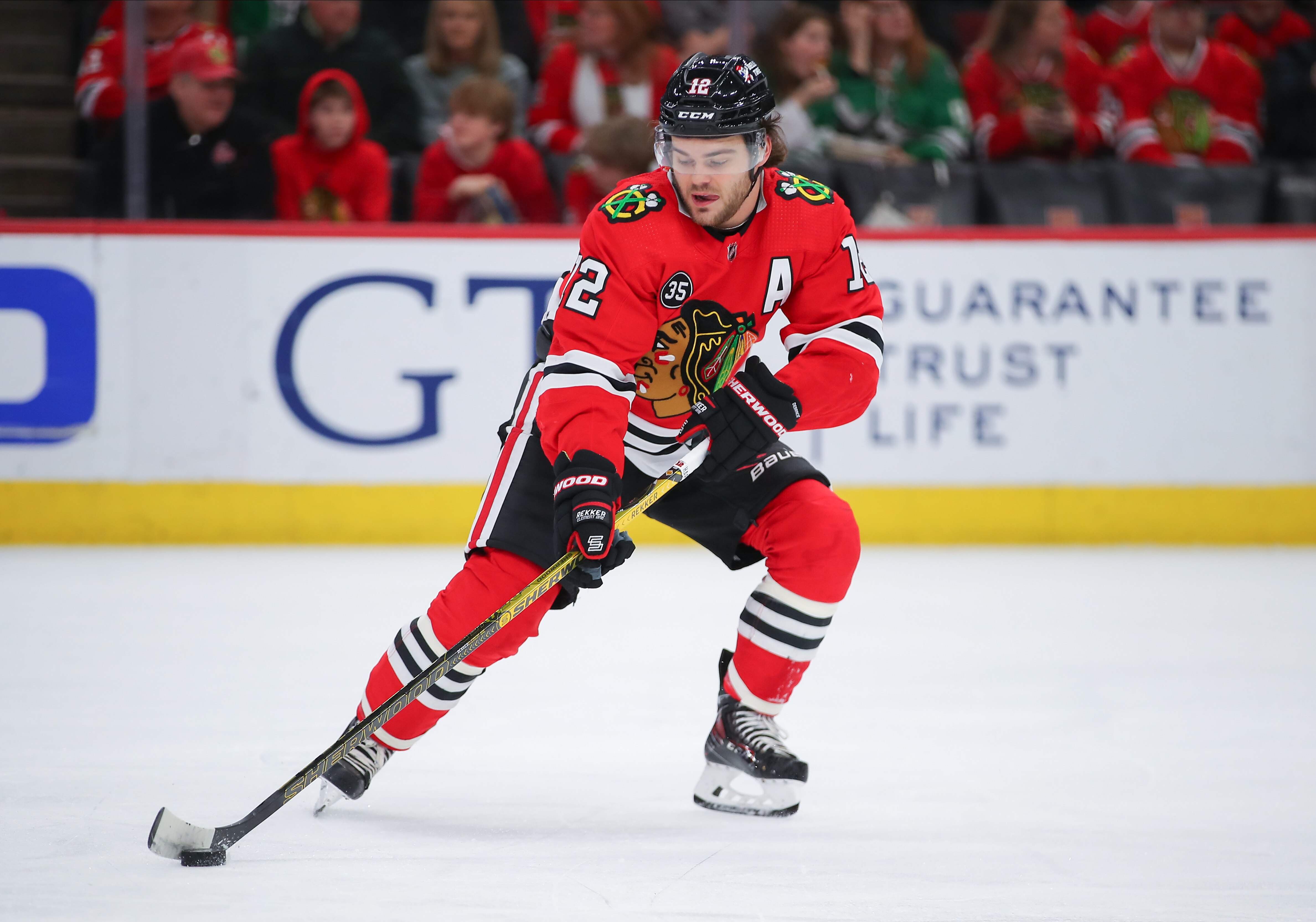 CHICAGO, IL - APRIL 10: Chicago Blackhawks left wing Alex DeBrincat (12) skates with the puck in action during a game between the Dallas Stars and the Chicago Blackhawks on April 10, 2022 at the United Center in Chicago, IL. (Photo by Melissa Tamez/Icon Sportswire via Getty Images)