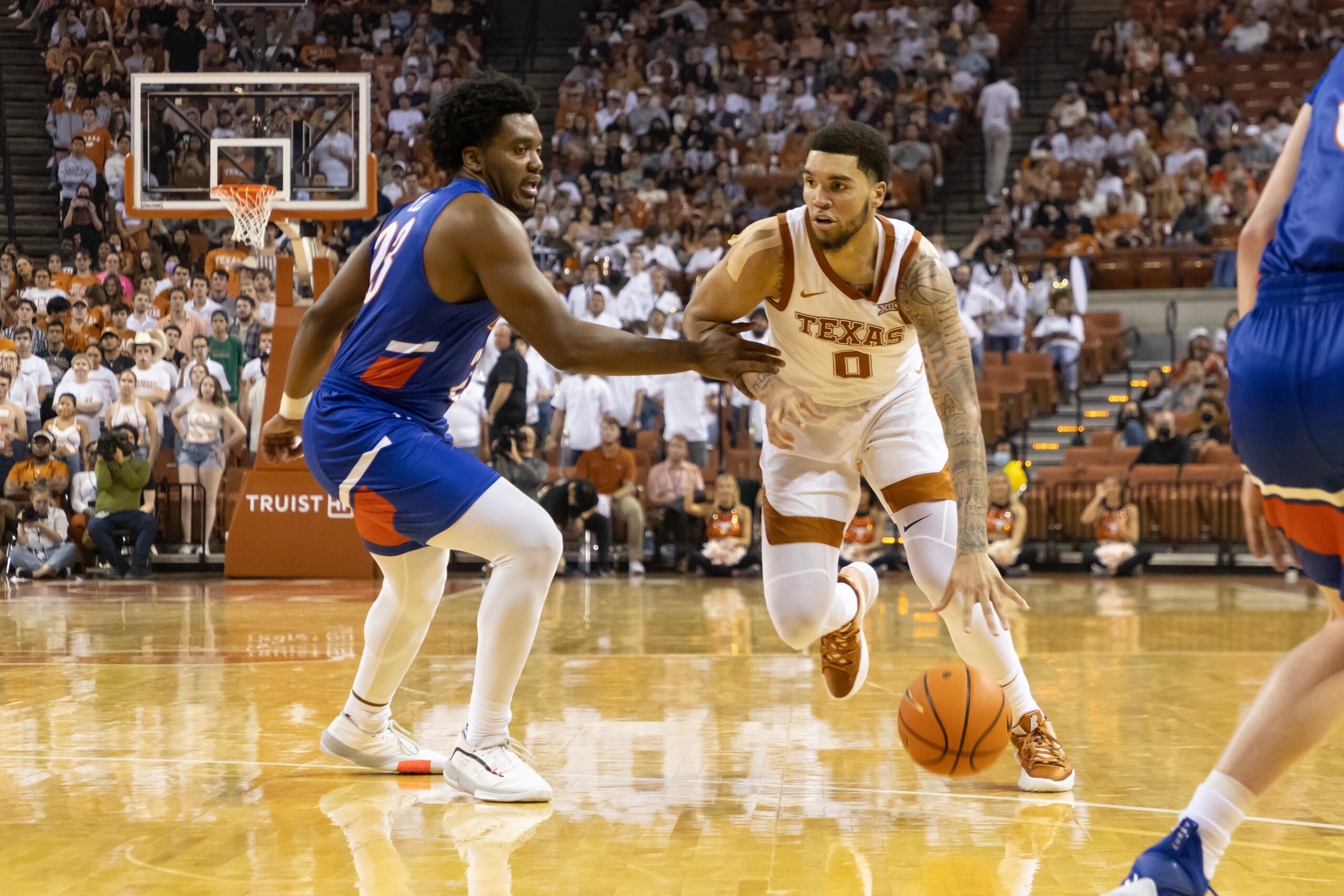 AUSTIN, TX - NOVEMBER 09: Timmy Allen (0) of the Texas Longhorns drives past Darius Lee (23) of the Houston Baptist Huskies game between the Texas Longhorns and the Houston Baptist Huskies at Frank Erwin Center in Austin, TX on November 9, 2021. (Photo by David Buono/Icon Sportswire via Getty Images) AUSTIN, TX - NOVEMBER 09: Timmy Allen (0) of the Texas Longhorns drives past Darius Lee (23) of the Houston Baptist Huskies game between the Texas Longhorns and the Houston Baptist Huskies at Frank Erwin Center in Austin, TX on November 9, 2021. (Photo by David Buono/Icon Sportswire via Getty Images)