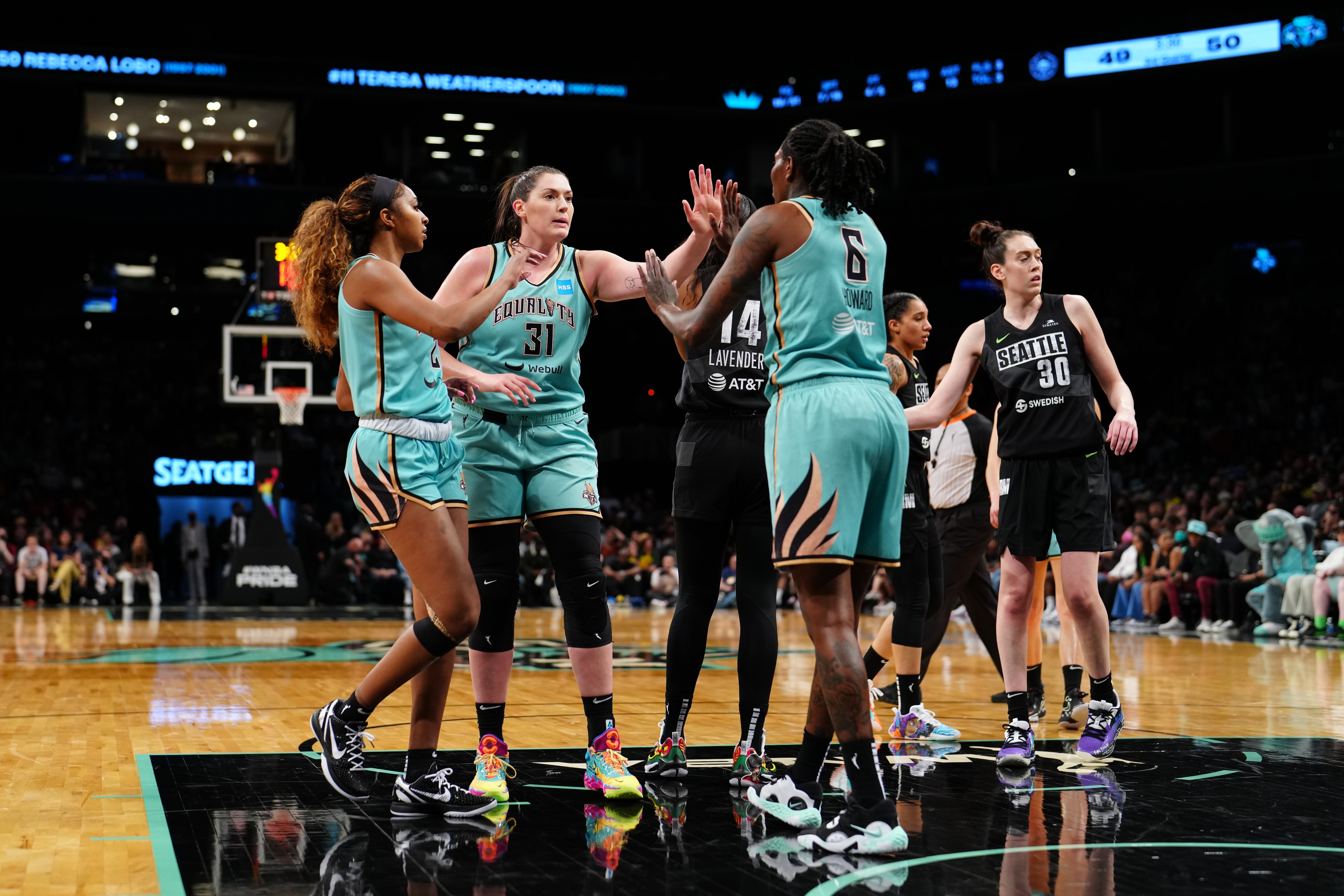 BROOKLYN, NY - JUNE 19: Stefanie Dolson #31 hi-fives DiDi Richards #2 and Natasha Howard #6 of the New York Liberty during the game against the Seattle Storm on June 19, 2022 at the Barclays Center in Brooklyn, New York. NOTE TO USER: User expressly acknowledges and agrees that, by downloading and or using this photograph, user is consenting to the terms and conditions of the Getty Images License Agreement. Mandatory Copyright Notice: Copyright 2022 NBAE (Photo by Evan Yu/NBAE via Getty Images)
