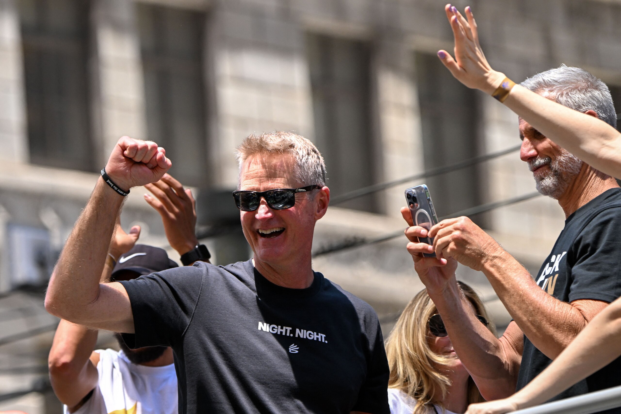 Head coach Steve Kerr (C) waves with coaching staff from a double decker bus during the Golden State Warriors NBA Championship victory parade along Market Street in San Francisco, California on June 20, 2022. (Photo by Patrick T. FALLON / AFP) (Photo by PATRICK T. FALLON/AFP via Getty Images) Head coach Steve Kerr (C) waves with coaching staff from a double decker bus during the Golden State Warriors NBA Championship victory parade along Market Street in San Francisco, California on June 20, 2022. (Photo by Patrick T. FALLON / AFP) (Photo by PATRICK T. FALLON/AFP via Getty Images)