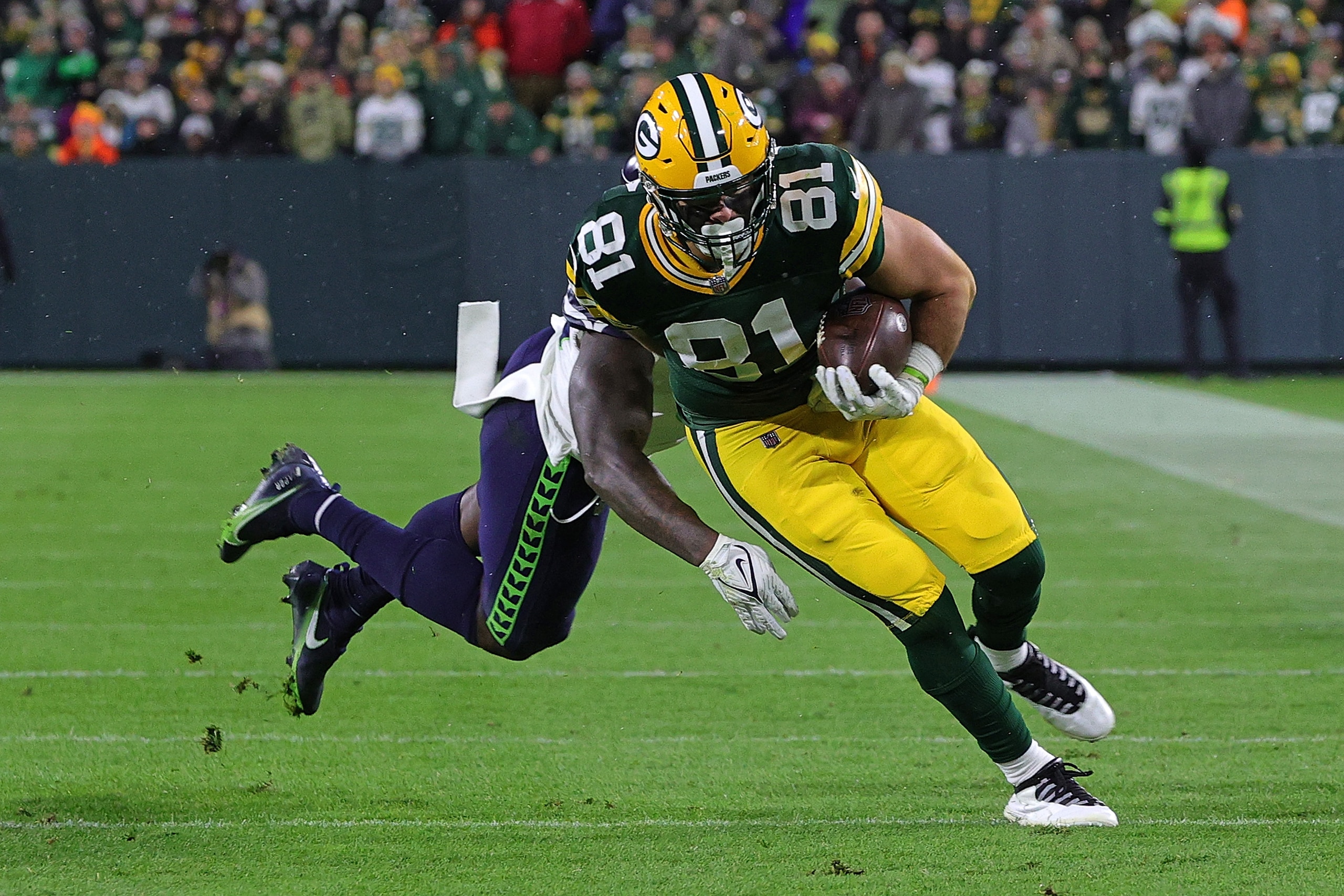 GREEN BAY, WISCONSIN - NOVEMBER 14: Josiah Deguara #81 of the Green Bay Packers is pursued by Benson Mayowa #10 of the Seattle Seahawks during a game at Lambeau Field on November 14, 2021 in Green Bay, Wisconsin.  The Packers defeated the Seahawks 17-0.  (Photo by Stacy Revere/Getty Images)