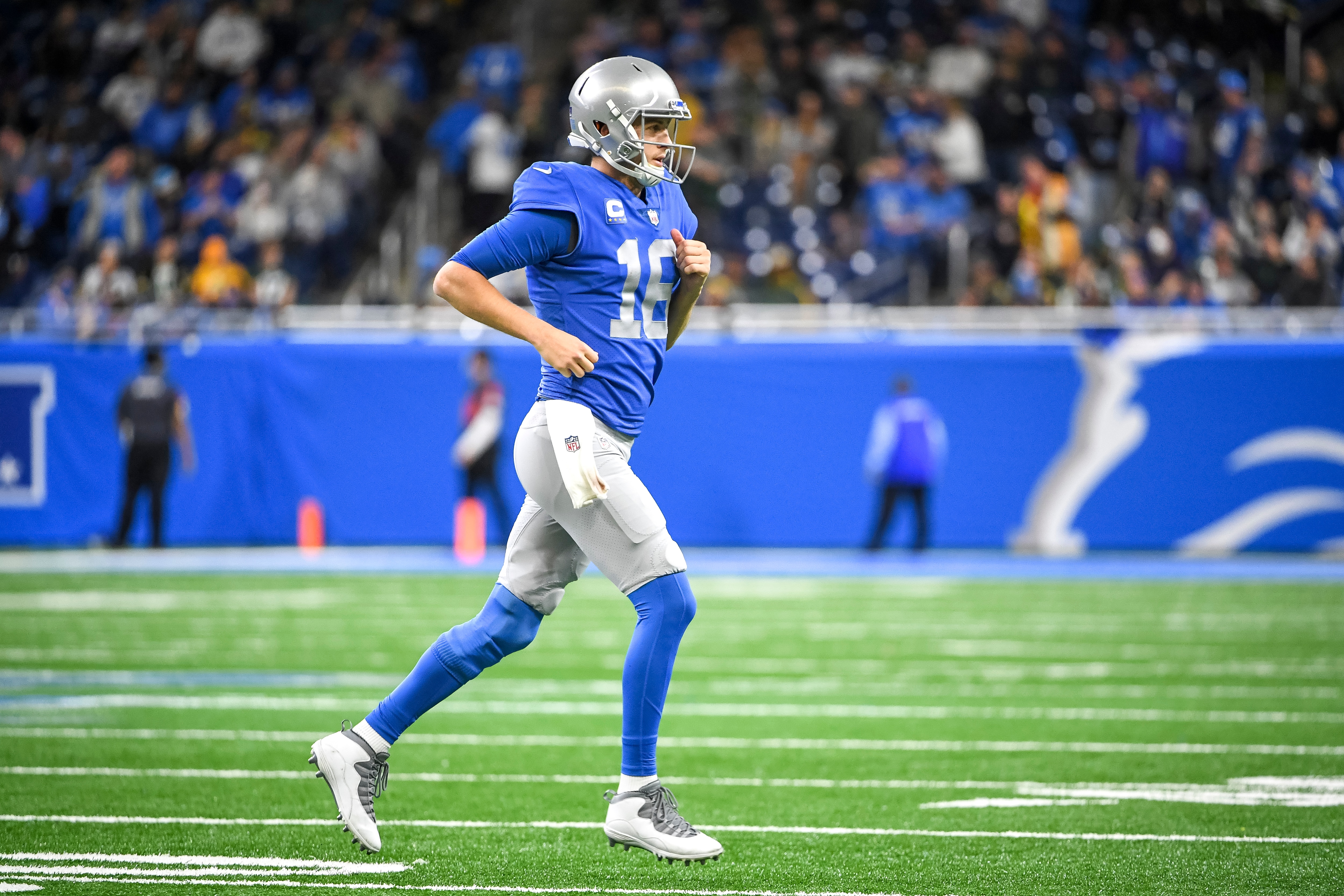 DETROIT, MICHIGAN - JANUARY 09: Jared Goff #16 of the Detroit Lions runs off the field against the Green Bay Packers at Ford Field on January 09, 2022 in Detroit, Michigan. (Photo by Nic Antaya/Getty Images)
