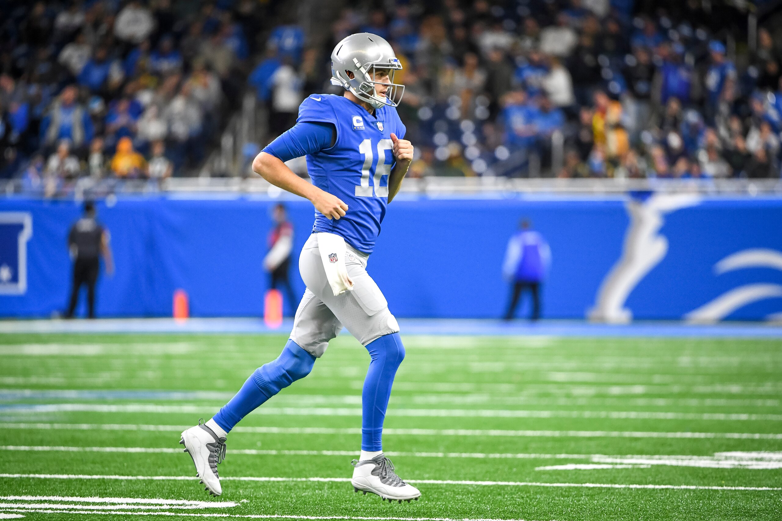 DETROIT, MICHIGAN - JANUARY 09: Jared Goff #16 of the Detroit Lions runs off the field against the Green Bay Packers at Ford Field on January 09, 2022 in Detroit, Michigan. (Photo by Nic Antaya/Getty Images) DETROIT, MICHIGAN - JANUARY 09: Jared Goff #16 of the Detroit Lions runs off the field against the Green Bay Packers at Ford Field on January 09, 2022 in Detroit, Michigan. (Photo by Nic Antaya/Getty Images)