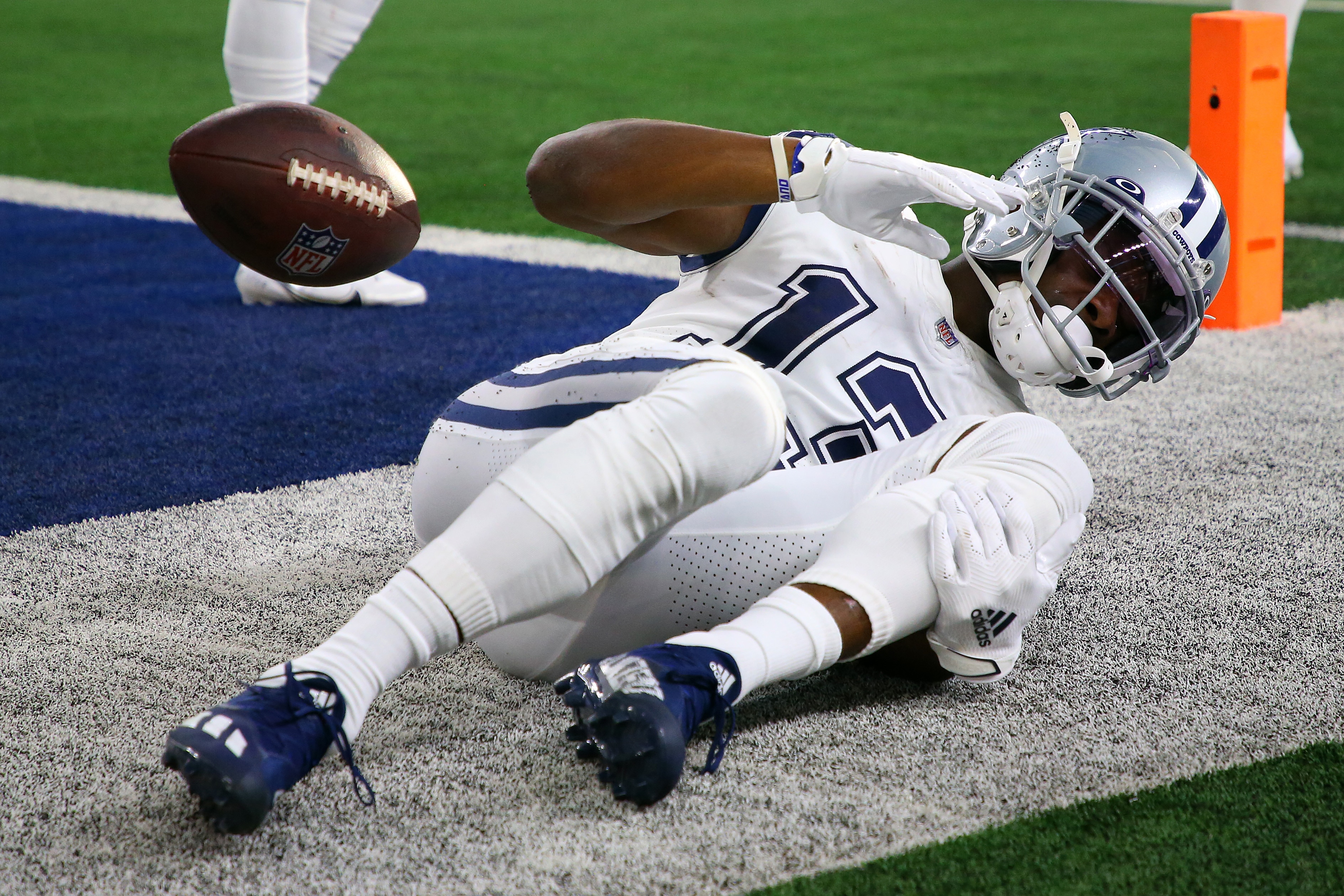 ARLINGTON, TEXAS - JANUARY 02: Michael Gallup #13 of the Dallas Cowboys holds his leg after catching the ball for a touchdown during the second quarter against the Arizona Cardinals at AT&T Stadium on January 02, 2022 in Arlington, Texas. (Photo by Richard Rodriguez/Getty Images)