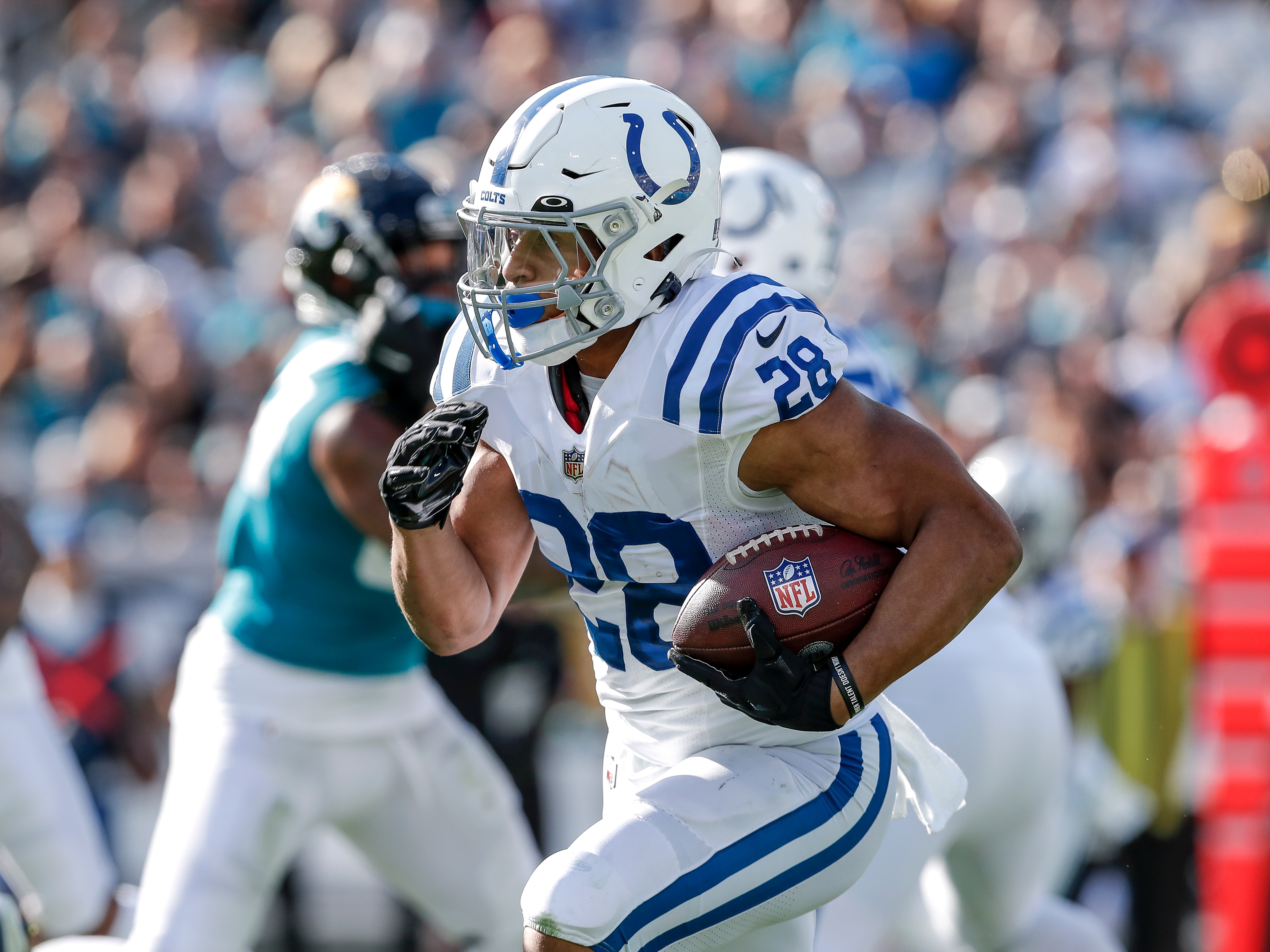 JACKSONVILLE, FL - JANUARY 9: Running back Jonathan Taylor #28 of the Indianapolis Colts rushes against the Jacksonville Jaguars at TIAA Bank Field on January 9, 2022 in Jacksonville, Florida. The Jaguars won 26 -11. (Photo by Don Juan Moore/Getty Images)