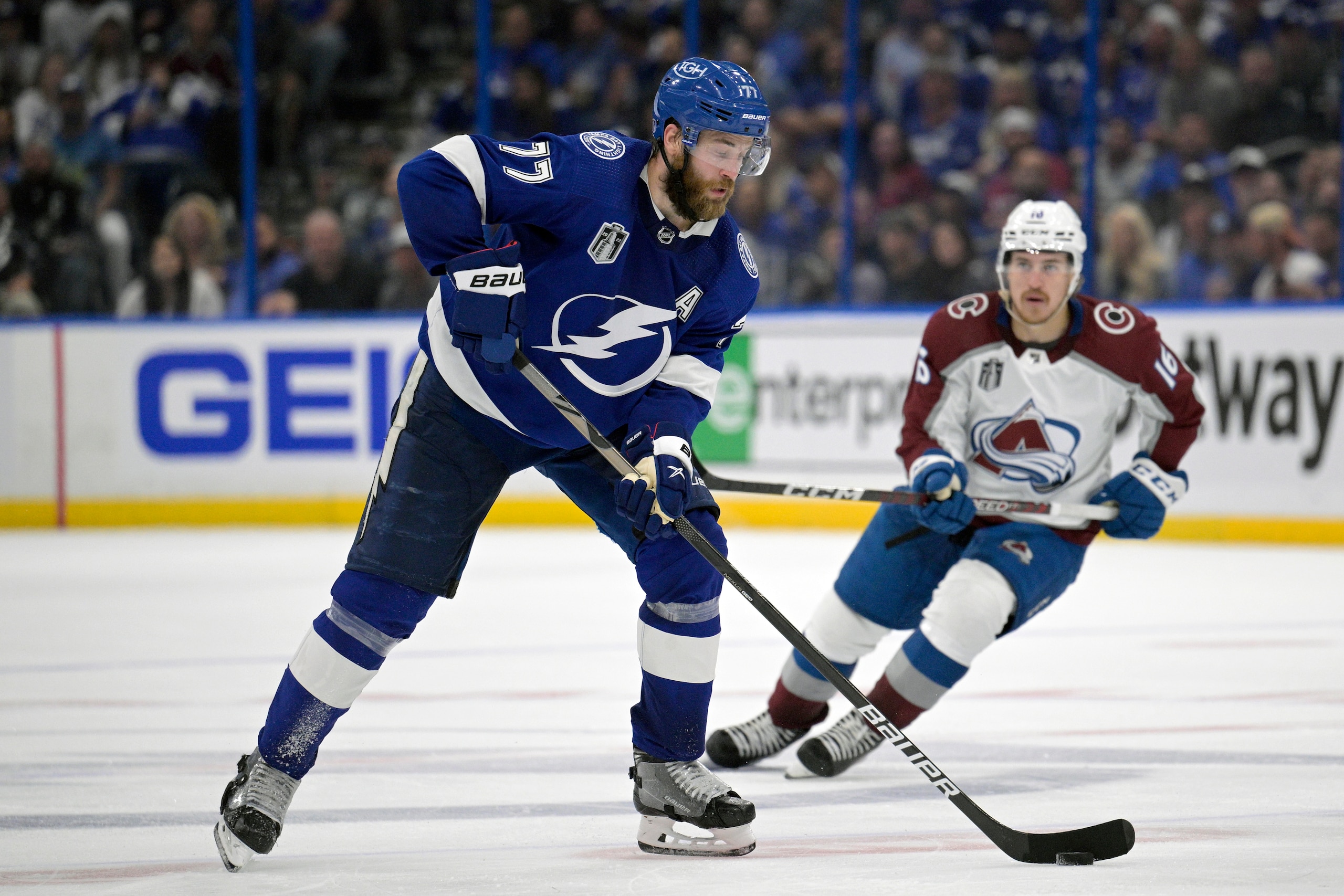 Tampa Bay Lightning defenseman Victor Hedman (77) controls a puck in front of Colorado Avalanche right wing Nicolas Aube-Kubel (16) during the third period of Game 3 of the NHL hockey Stanley Cup Finals on Monday, June 20, 2022, in Tampa, Fla. (AP Photo/Phelan M. Ebenhack)