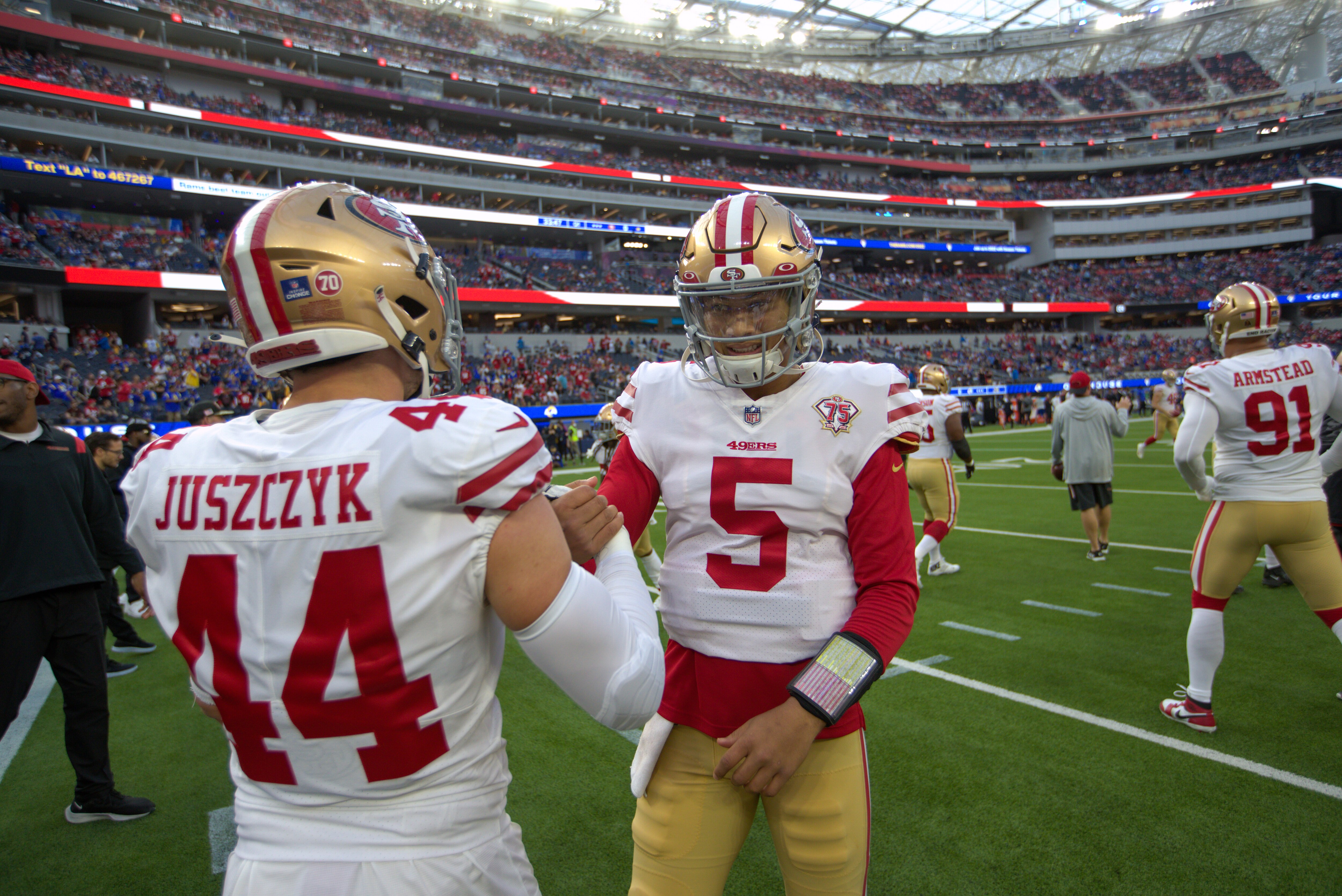 INGLEWOOD, CA - JANUARY 30: Kyle Juszczyk #44 and Trey Lance #5 of the San Francisco 49ers on the field before the game against the Los Angeles Rams at SoFi Stadium on January 30, 2022 in Inglewood, California. The Rams defeated the 49ers 20-17. (Photo by Michael Zagaris/San Francisco 49ers/Getty Images)