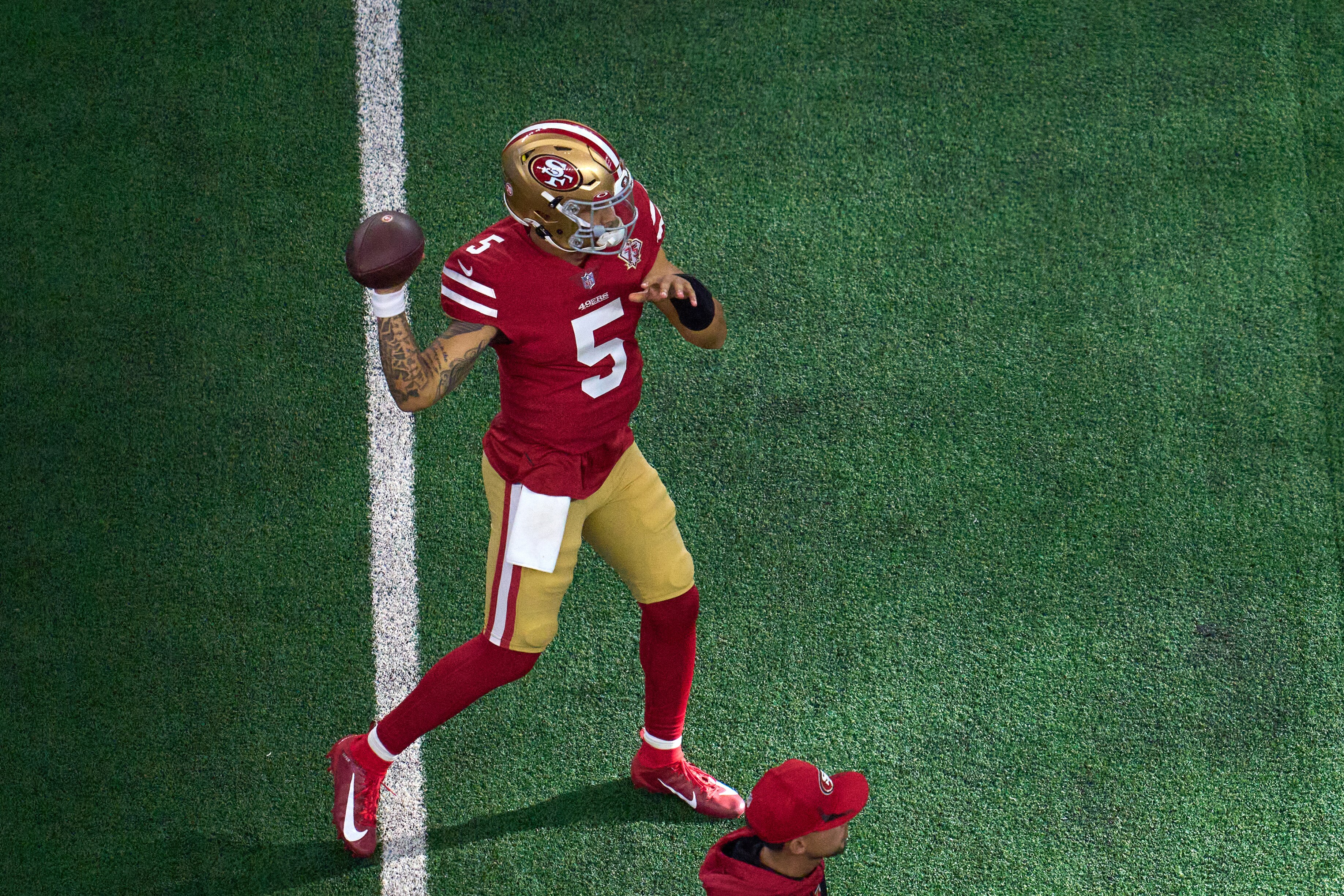 ARLINGTON, TX - JANUARY 16: San Francisco 49ers quarterback Trey Lance (5) warms up with the football during the NFC Wild Card game between the San Francisco 49ers and the Dallas Cowboys on January 16, 2022 at AT&T Stadium in Arlington, TX. (Photo by Robin Alam/Icon Sportswire via Getty Images)