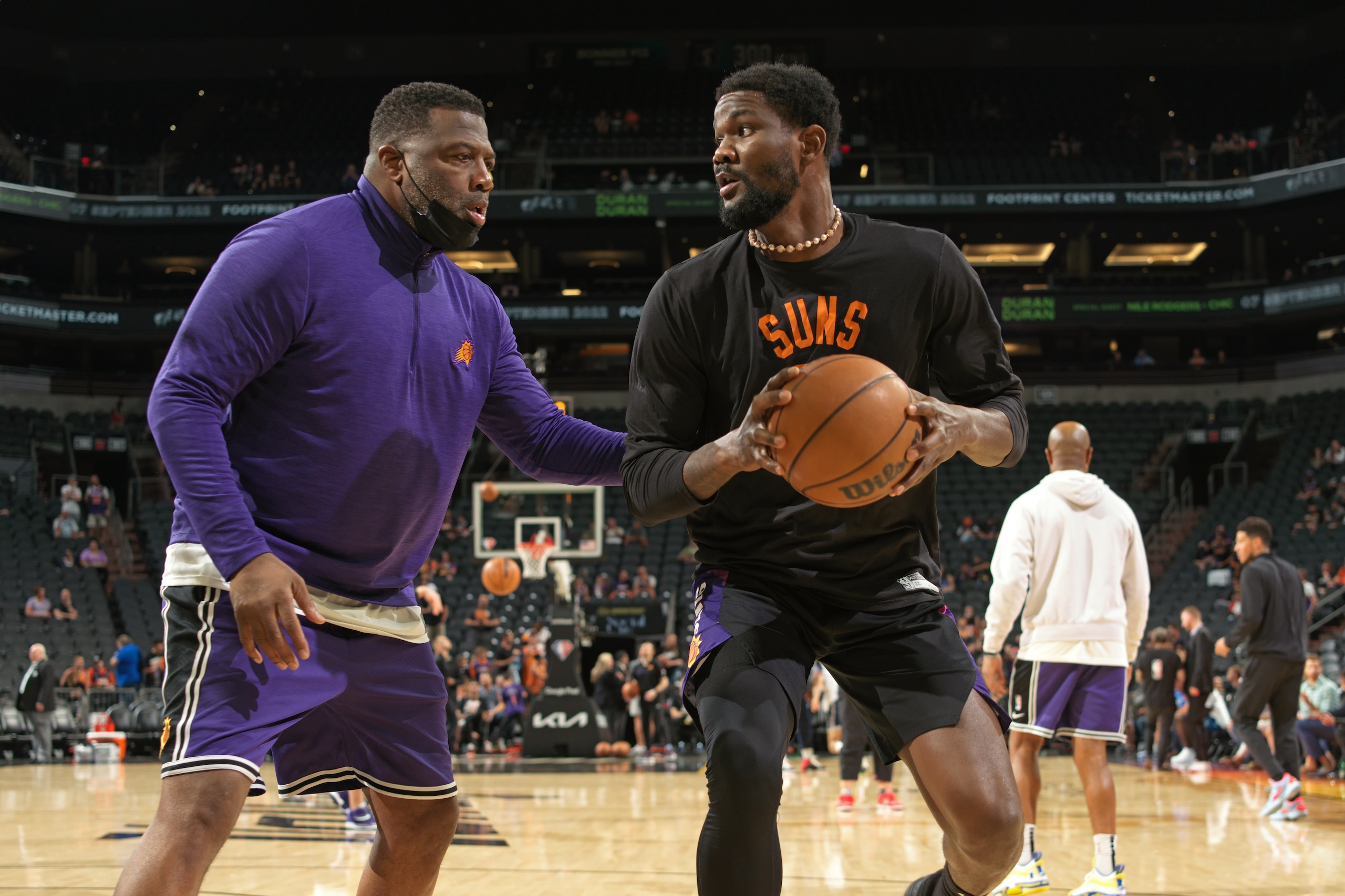 PHOENIX, AZ - MAY 10: Assistant Coach Mark Bryant helps Deandre Ayton #22 of the Phoenix Suns warm up before the game against the Dallas Mavericks during Game 5 of the 2022 NBA Playoffs Western Conference Semifinals on May 10, 2022 at Footprint Center in Phoenix, Arizona. NOTE TO USER: User expressly acknowledges and agrees that, by downloading and or using this photograph, user is consenting to the terms and conditions of the Getty Images License Agreement. Mandatory Copyright Notice: Copyright 2022 NBAE (Photo by Barry Gossage/NBAE via Getty Images)