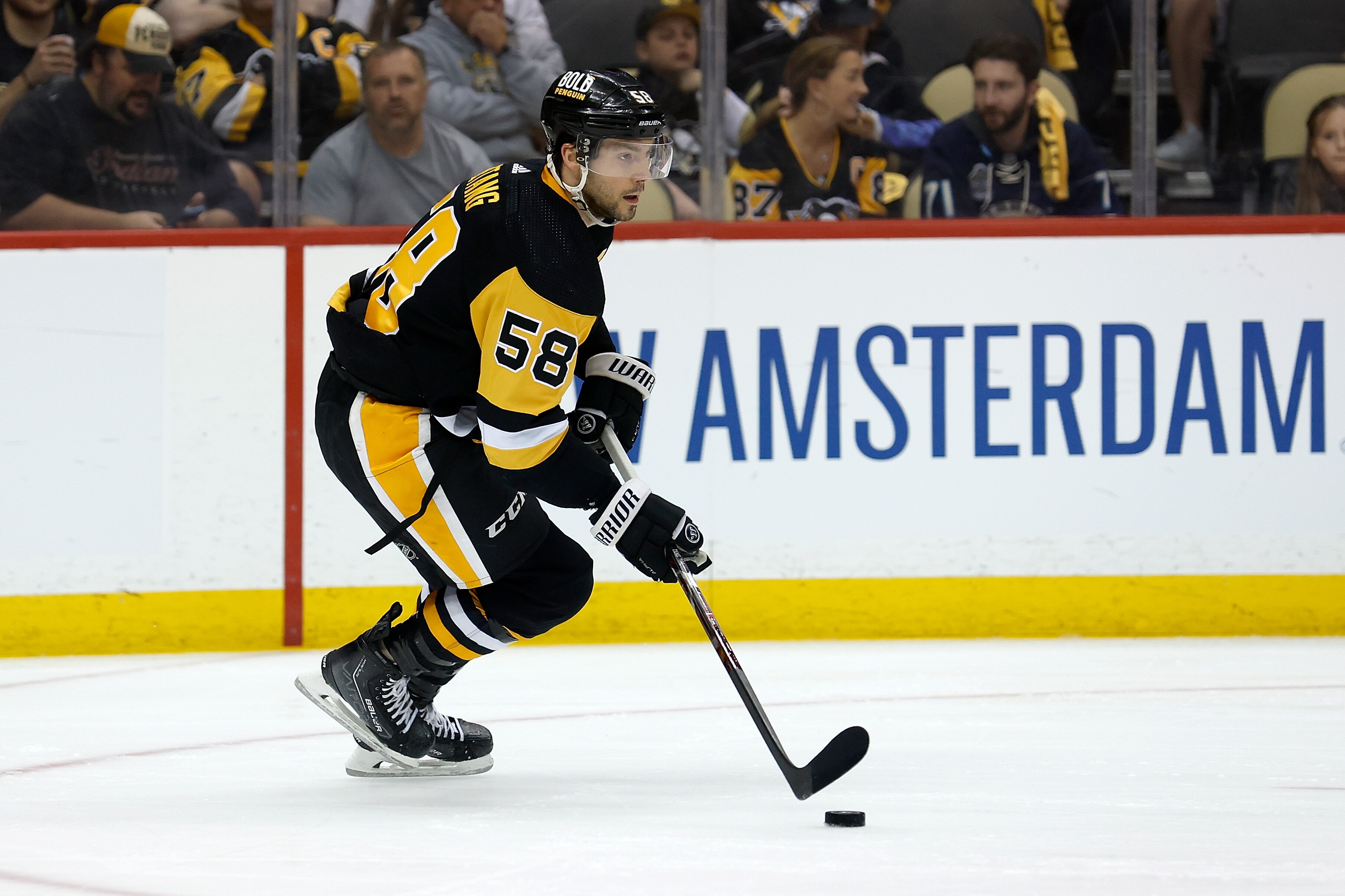 PITTSBURGH, PA - MAY 13:  Kris Letang #58 of the Pittsburgh Penguins controls the puck in Game Six of the First Round of the 2022 Stanley Cup Playoffs against the New York Rangers at PPG PAINTS Arena on May 13, 2022 in Pittsburgh, Pennsylvania. (Photo by Kirk Irwin/Getty Images)