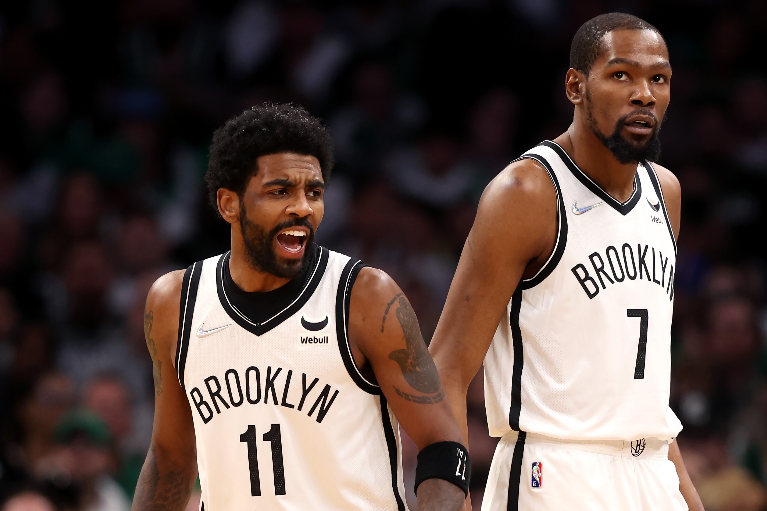 BOSTON, MASSACHUSETTS - APRIL 17: Kyrie Irving #11 of the Brooklyn Nets and Kevin Durant #7 look on during the first quarter of Round 1 Game 1 of the 2022 NBA Eastern Conference Playoffs against the Boston Celtics at TD Garden on April 17, 2022 in Boston, Massachusetts. (Photo by Maddie Meyer/Getty Images)