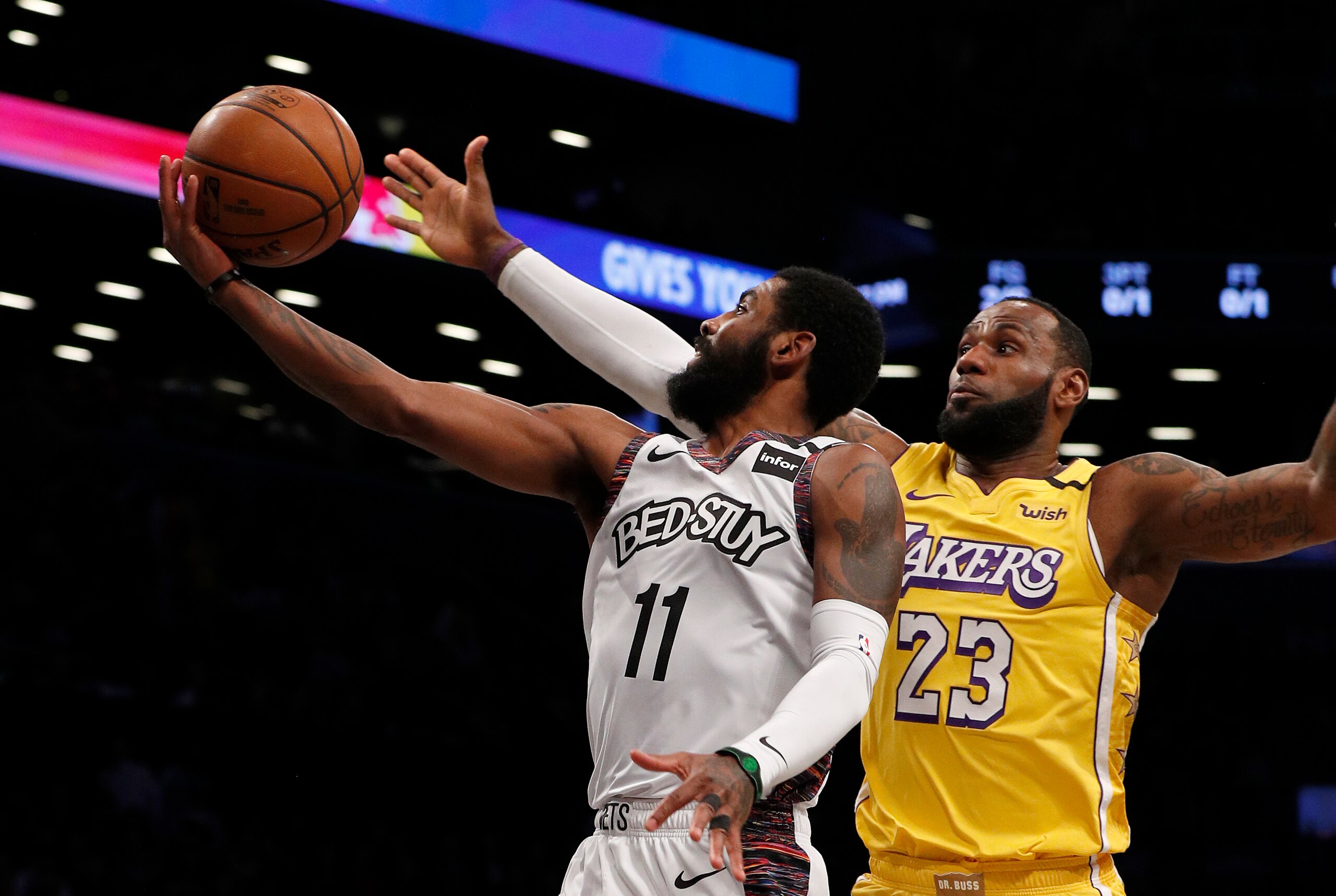 NEW YORK, NEW YORK - JANUARY 23:  (NEW YORK DAILIES OUT)   Kyrie Irving #11 of the Brooklyn Nets in action against LeBron James #23 of the Los Angeles Lakers at Barclays Center on January 23, 2020 in New York City. The Lakers defeated the Nets 128-113. NOTE TO USER: User expressly acknowledges and agrees that, by downloading and or using this photograph, User is consenting to the terms and conditions of the Getty Images License Agreement. (Photo by Jim McIsaac/Getty Images)