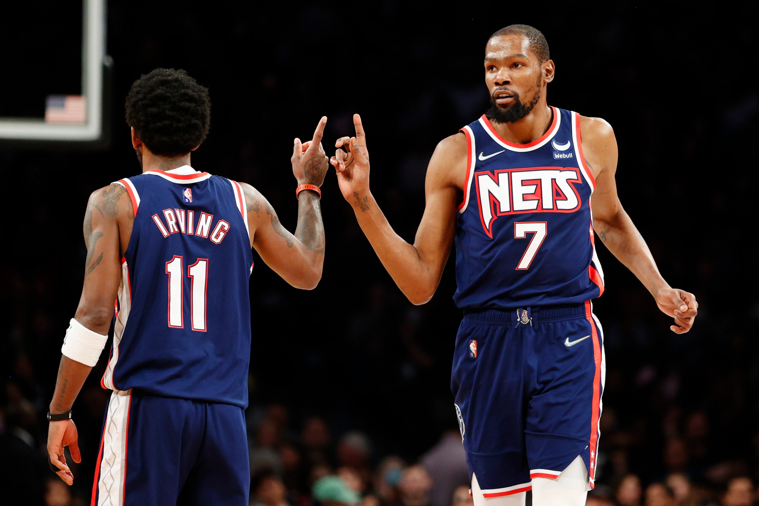 NEW YORK, NEW YORK - APRIL 10: Kevin Durant #7 reacts with Kyrie Irving #11 of the Brooklyn Nets during the second half against the Indiana Pacers at Barclays Center on April 10, 2022 in the Brooklyn borough of New York City. The Nets won 134-126. NOTE TO USER: User expressly acknowledges and agrees that, by downloading and or using this photograph, User is consenting to the terms and conditions of the Getty Images License Agreement. (Photo by Sarah Stier/Getty Images)