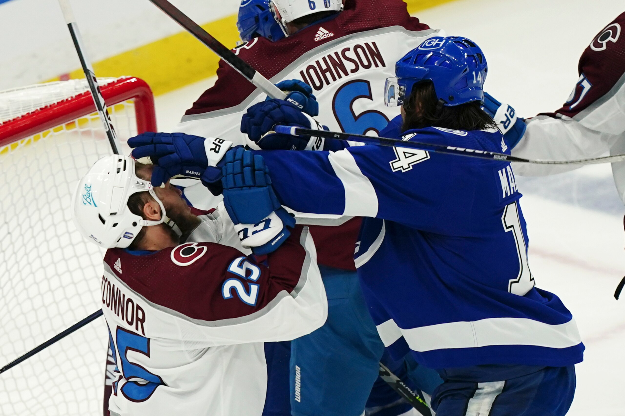 Tampa Bay Lightning left wing Pat Maroon, right, shoves Colorado Avalanche right wing Logan O'Connor (25) during the first period of Game 4 of the NHL hockey Stanley Cup Finals on Wednesday, June 22, 2022, in Tampa, Fla. (AP Photo/John Bazemore)